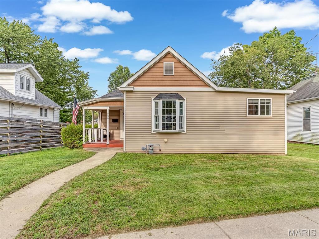 Welcome to this quaint, move-in-ready one-story home nestled in the historic Leclaire District of Edwardsville! This sought after location is within walking distance to so many amenities.  Light and airy throughout, the home features tall ceilings, generously sized rooms, and a welcoming covered front porch with plenty of space to relax and enjoy the neighborhood. The eat-in kitchen offers abundant cabinet storage along with a pantry, a convenient breakfast bar, and stainless steel appliances. The spacious primary bedroom features its own en-suite bathroom for added comfort and privacy. Outside, enjoy the privacy-fenced backyard with a deck—perfect for entertaining, relaxing, or enjoying your morning coffee. A rear driveway with alley access provides valuable additional off-street parking. Offering charm, functionality, and an ideal location, this home is ready for its next owner. All appliances, including the washer and dryer, are included!  Unfinished basement provides plenty of room for storage. VA assumable loan.