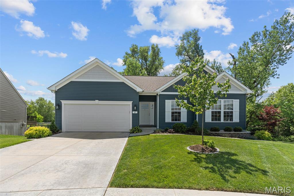 Welcome home to this beautifully maintained 4 bed, 3 bath ranch tucked away on a quiet cul-de-sac in sought-after Wentzville! Just 5 years young, this open-concept home offers the perfect blend of style, comfort, and functional living. The vaulted main living area features easy-care wood laminate flooring, a cozy gas fireplace, and a wall of windows that fills the space with natural light. The kitchen is designed for gathering with granite countertops, stainless steel appliances, center island with breakfast bar, and a seamless flow into the dining area. Step outside to the screened-in deck with Eze-Breeze vinyl windows and enjoy peaceful backyard views backing to trees for added privacy.
The main level offers three bedrooms with ceiling fans, including a spacious primary suite with tray ceiling, walk-in closet with custom shelving, and private bathroom with dual sinks. Two additional bedrooms, a full hall bath, and convenient main floor laundry complete the main floor. The finished walkout lower level expands your living space with a large family/rec room, 4th bedroom, full bath, plus additional unfinished space ideal for recreation, hobbies, or storage. Walk out to the large patio with partially covered area and enjoy the fully fenced backyard with irrigation system and wooded backdrop. Fantastic location close to highways, restaurants, shopping, everyday amenities, and the Wentzville Rec Center—this one checks all the boxes! Schedule your showing today!
