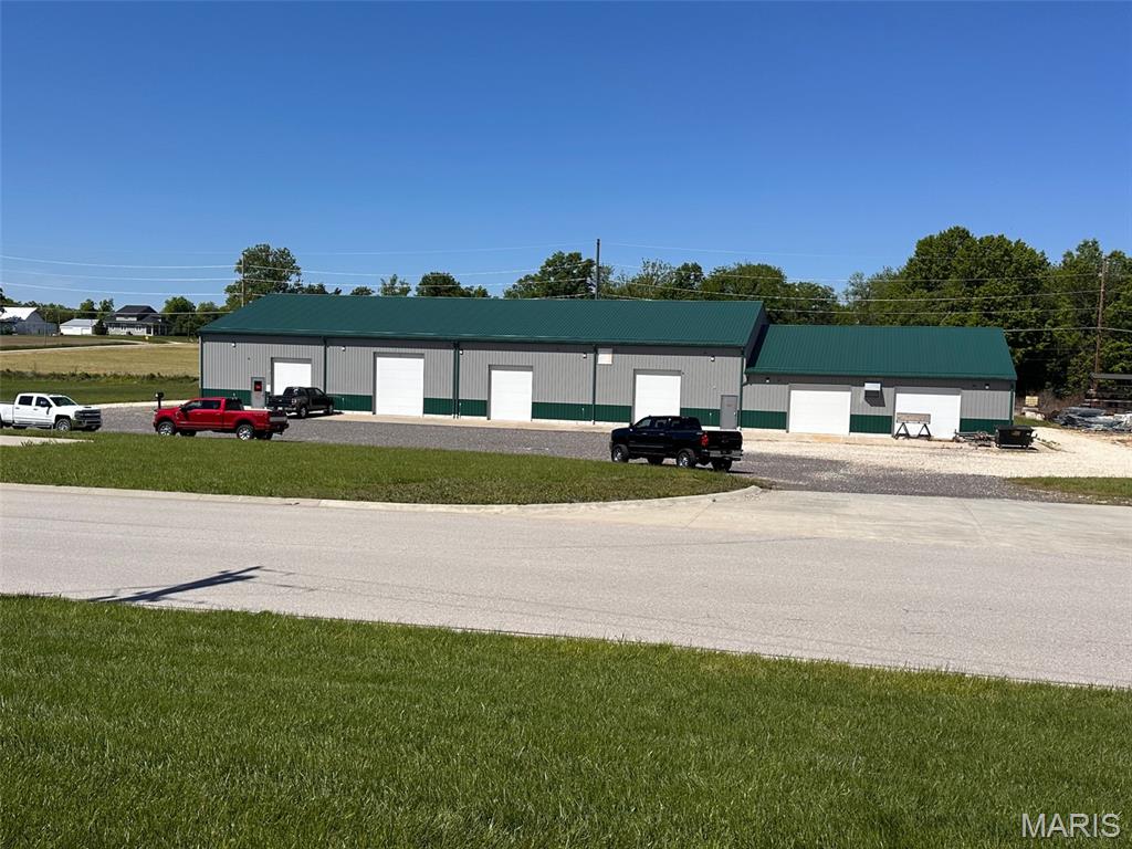 Here is your opportunity to own a top-tier multi-use facility located in the New Haven, MO industrial park.  Constructed with exceptional attention to detail and no expense spared, this property delivers a rare combination of functionality, durability, and refined workspace design.  It is a fantastic place to start or expand your business!
This multi-use property is currently in service as a high end automobile restoration business but could be used for a wide variety of purposes.  Sitting on just over 2.5 acres the total footprint is approximately 60' x 180' with over 17' ceilings throughout the main area, multiple overhead doors with openers, large parking lot,  professional offices, mezzanine storage, 2 bathrooms, (1 handicap accessible) three phase and single phase electric with multiple panels rated at 600 amps and 225 amps.  

This building offers both overhead radiant heat throughout along with Central A/C, louvered exhaust fans, and polished concrete floor for easy clean up.  Both compressed air and water lines are located throughout the building for efficiency and convenience.  High bay LED lights throughout the building are 

This property truly has too many features to list!  Schedule an appointment to check it out TODAY!