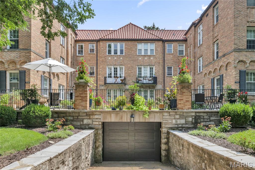 Beautifully maintained 2 bedroom, 1 bath Clayton condo in The Moorlands, offering classic charm and an inviting courtyard setting. The light-filled living room overlooks the landscaped courtyard, with wainscoting that continues into the kitchen. The open kitchen and dining area offers newer stainless steel appliances, white cabinetry, granite countertops, and a breakfast bar, creating a seamless connection to the living space. Both bedrooms and the entry closet have built-in shelving and hanging space for added storage, while hardwood floors and classic architectural details, such as the stained-glass window, add warmth throughout. The lower level includes one assigned garage parking space, a locked private storage unit, and a shared laundry room. Move-in ready, this welcoming condo offers the perfect blend of comfort, convenience, and functionality in one of Clayton’s most desirable neighborhoods.