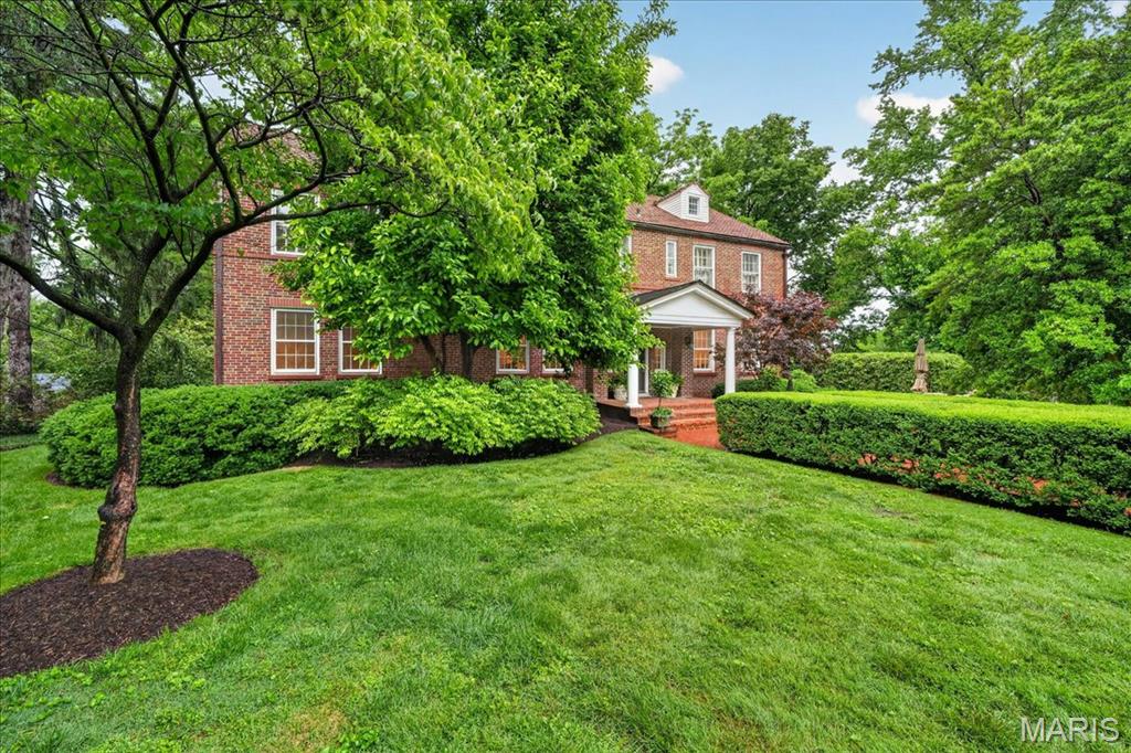 Built in 1936, this charming 4-bedroom, 4.5-bath home beautifully blends timeless architectural character with thoughtful modern updates in a prime Ladue location. From the moment you arrive, the inviting front patio and picturesque 1+ acre lot set the tone for this special property. Inside, rich wood floors, high ceilings, and significant architectural details create warmth and elegance throughout. The spacious living room offers an ideal setting for both everyday living and entertaining. A functional main-floor laundry room adds convenience to the home’s classic layout. The expansive primary suite is a true retreat, featuring a private sitting room or office, generous closet space, and a spacious bath with separate vanities, a soaking tub, and large shower. Three additional bedrooms and two full baths complete the second floor, offering ample space for family and guests. The finished lower level provides additional living and entertaining space along with a full bath, ideal for a recreation room, fitness area, or guest suite. Surrounded by mature landscaping and set on over an acre, this exceptional property offers privacy, beauty, and convenience in one of Ladue’s most desirable locations. A rare opportunity to own a home filled with charm, character, and modern comfort.