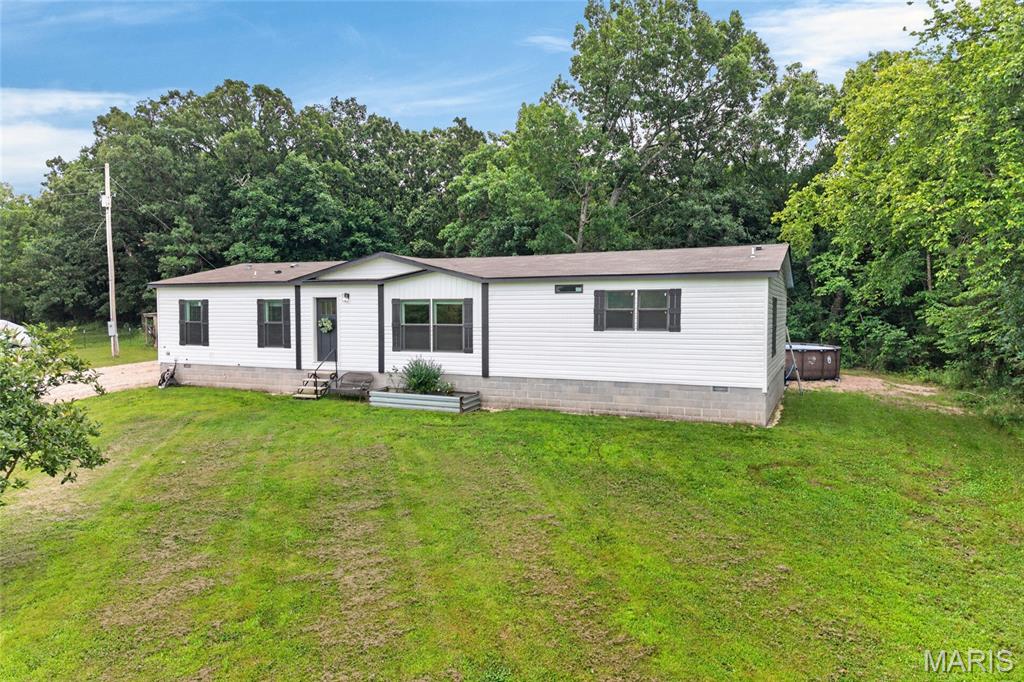 This property has it all! This home was brand new in 2024 and is absolutely a showstopper! This three bedroom, two bathroom residence sits on 8.38 acres with the perfect blend of open ground and woods for the avid hunter in your family. This home includes the most incredible features that set it apart! The hide away pantry in the kitchen has room for your staple snacks, canning supplies, and those pesky appliances that you don't want out on your kitchen countertops. The utility room has a wash station for your indoor pets to make bathing a breeze! Your primary bedroom has a stunning ensuite bathroom that features a soaker tub that you will never want to leave! Moving outdoors to your large back deck you can enjoy the above ground pool that is brand new this year! There are two fields located on this property with one fenced for those that have dreamed of their own hobby farm. You will not want to sleep on this gorgeous property, it won't be around long! Schedule your private tour today!