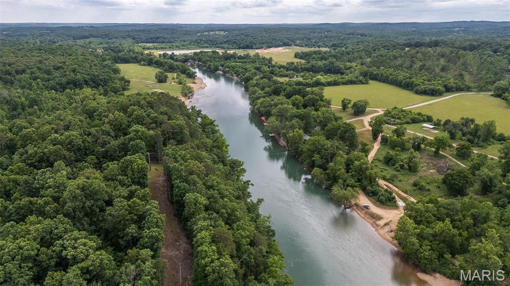 Perched above the scenic Current River just minutes from Doniphan sits this ~1.5 acre lot full of potential! Situated on an elevated hill well above flood stage, this property features breathtaking panoramic views of the river and a west-facing setting that delivers unforgettable sunsets over the water. The property also offers convenient river access and a nearby community boat ramp, making it easy to spend your days floating, fishing, or exploring the water. With community well access available, this property is ready for your dream getaway cabin or campsite. Whether you’re searching for a weekend escape or a place to enjoy the beauty of the Ozarks year-round, this is a rare opportunity to own your own slice of Current River paradise!
