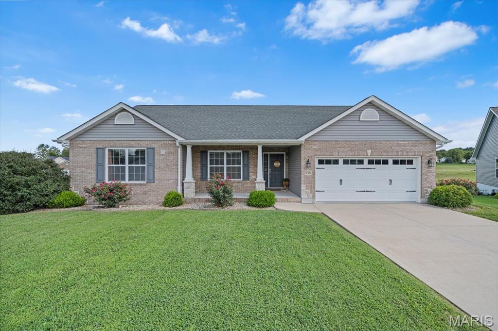 Sitting in the desired Orchard Lakes neighborhood, this inviting ranch offers the kind of setting that makes coming home something to look forward to. Tucked away on a quiet cul-de-sac with beautiful lake views, the home combines thoughtful design, generous spaces, and plenty of room to entertain. Inside, the floor plan creates an effortless flow between the main living areas, with vaulted ceilings adding an airy, open feel. The spacious kitchen is truly the heart of the home, featuring granite countertops, a large center island, and an oversized walk-in pantry. Ideal for everything from casual mornings to hosting friends and family. The vaulted primary suite provides a relaxing retreat, complete with dual closets and a well-appointed private bath. Additional oversized bedrooms offer plenty of flexibility for family, guests, or a home office. Looking for even more potential? The full daylight basement provides a blank canvas for future living space, recreation, a home gym, or whatever fits your lifestyle. Step outside and the appeal continues. A 14x14 deck extends from the kitchen and dining area, creating an ideal spot for outdoor dining while the patio and built-in fire pit set the stage for evenings under the stars. Out front, the craftsman-inspired elevation and stone accents make a welcoming first impression, while the covered porch offers a front-row seat to gorgeous lake views. All of this comes with a location that's just minutes from Scott Air Force Base, with convenient access to Route 15 and Downtown St. Louis.