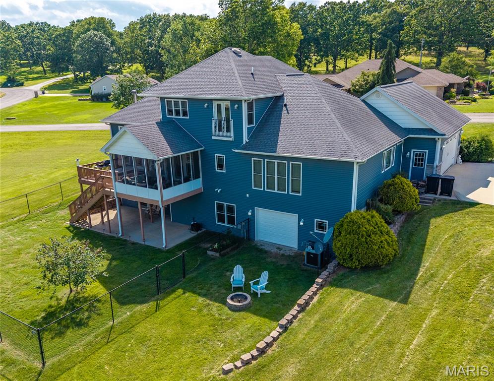 Check out this 1.5 Custom Home on a double corner lot. Updated Kitchen with Quartz countertops with soft-close and pull-out drawers. Pantry. Island, Eat-In, Separate Dining, and Formal Dining. Plus an abundance of custom-built shelving in all closets, den, etc. All stays. All walk-in closets throughout.
This is truly one of a kind. Lots of windows for natural lighting. 16' ceilings in the living room. 
Real Hardwood flooring. Screened in Porch, large deck, patio, wrap-around covered front porch.
Spacious primary bedroom with tray ceiling. Full primary bathroom with a soaking tub and a large walk-in tile shower. Custom closet with every kind of built-in. Double sinks and ample space to move around.
The laundry room is just as spacious, with cabinets, a built-in ironing board, and ample storage.
The oversized car garage provides convenient storage for all your belongings. 1/2 bath off the kitchen.
Gorgeous Staircases. Upstairs library/den with views! Some of the best shelving for all your books! 2 Bedrooms with walk-in closets and custom shelving. One bedroom with a French deck to look out. Full bath upstairs.
The basement includes a family room and a bonus space. Three-quarter bath and full bedroom with a walk-in closet. On the other side, the man cave with a wet bar, kitchenette, storage, and a John Deere Room. Walks out to the fire pit. The family room opens to a patio with a secure chain-link fence for pets or children.
*Newer blinds on windows throughout. (2019)
*Complete Water System and Water Filtration System 
*Water Heater Replacements (two)
*Updated kitchen with quartz countertops, subway tile backsplash, and new appliances
*Outlet lights added throughout the home
*Repainted
*Sprinkler System
*Central Vac
*Laundry Chute 
*Sound System
* 2nd Generation Whole House Generator installed 6/3/26 7 year transferable warranty
*List of Updates added to documents!