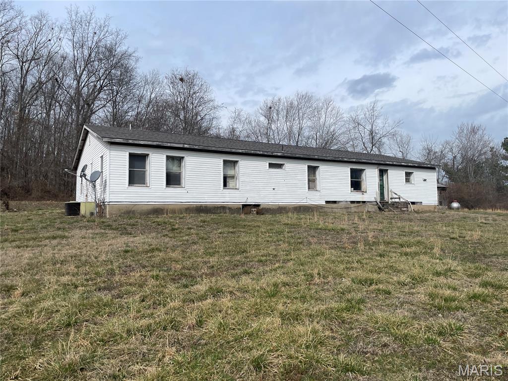 Nice location on dead end lane, just outside of town but near the golf course and Lon Sanders Canyon. Manufactured home with add on sitting on 4.19 acres m/l.  Home has living room, family room, kitchen, dining room, 3-bedrooms and 1-3/4-bath. Home has a new roof, is vinyl sided with an attached carport/patio area.  Detached garage and workshop with an add on. Lots of unfinished projects and remodeling has been started. Bring your creativity and elbow grease and make this house into your next country home.