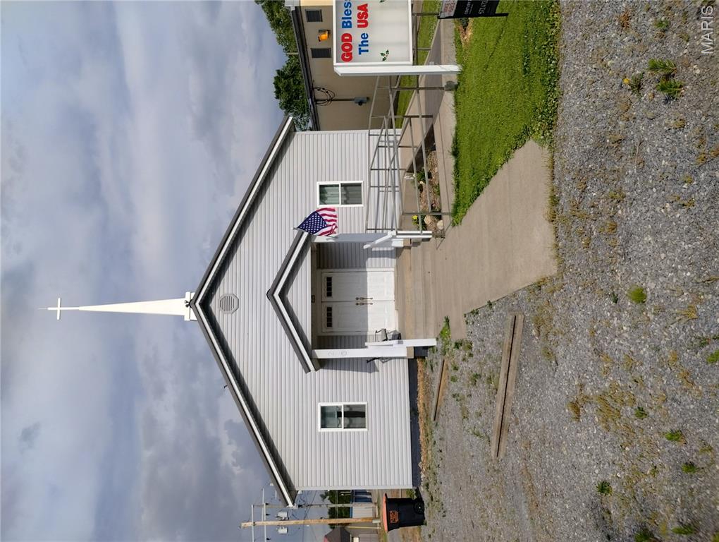 Commercial Building with On-Site Living Potential. This 2,340 SF commercial property offers a unique opportunity to operate a business with the flexibility for on-site living, making it ideal for retail, office, studio, professional service, or owner-operator use. Conveniently located just one block from Highway 25 with easy access to Cape Girardeau, Jackson, and Advance, the property includes five front parking spaces plus additional rear parking. Extensively renovated with more than $100,000 in improvements, this move-in-ready property features updated windows, doors, siding, foundation improvements, R-30 insulation, fresh interior paint, and dual-zone HVAC. Originally a 1950s church, the building has been thoughtfully repurposed while retaining its character and charm. The front offers 900+ SF of open showroom, office, or studio space, along with two private rooms ideal for offices, workspaces, storage, or potential bedrooms. Original hardwood floors, built-in bookcases, and an electric fireplace create a warm and inviting atmosphere. The rear section provides exceptional live/work flexibility with a large eat-in kitchen, spacious multi-purpose room, and 1½ baths. This area is ideal for private living quarters, employee space, client meetings, or expanded business operations. Additional upgrades include luxury vinyl plank flooring, a tankless water heater, and a reverse osmosis system. A 10' x 12' storage shed is included. Ideal for owner-operators, entrepreneurs, or investors seeking a move-in-ready commercial property with flexible live/work potential. A pre-inspection report is available upon request.
The building has been Pre-Inspected so be sure to ask your Realtor for a copy of it.
Duplicate Listing:  MLS # 26031252