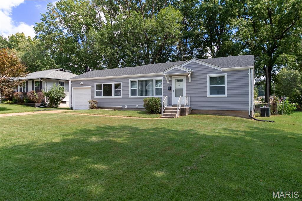 Charming, fully updated, and move-in ready! Nestled on a quiet street in Bellefontaine Neighbors, this beautiful 2-bedroom home boasts excellent curb appeal with durable vinyl siding and a great deck overlooking a spacious, level, fenced yard. Inside, the bright layout features modern vinyl plank flooring throughout and a stylish kitchen equipped with sleek granite countertops. Enjoy additional flexible living space in the versatile breezeway/bonus room, plus a partially finished lower level perfect for a recreation room, home office, or extra storage.