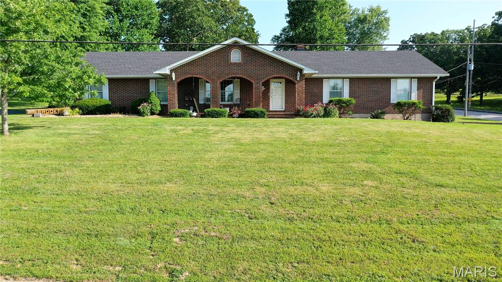 Custom brick home on .6437 acres within walking distance of Salem R-80 High School! Situated on a corner lot, the front porch offers the perfect spot to enjoy Friday night football. Built in 1982 by masonry craftsman Bill Elmer, this 4-bedroom (1 non-conforming), 3.5-bath home showcases a full brick exterior, 5 brick fireplaces, and beautiful brick accents throughout. The custom kitchen features solid wood cabinetry, stone backsplash, granite countertops, pantry/appliance storage, center island with cookbook storage, and included appliances. Spacious primary suite offers patio access, a large walk-in closet, and an updated bath with double sinks and tiled walk-in shower. Meticulously maintained landscaping surrounds a screened-in porch and patio perfect for entertaining. Main-level laundry with half bath, 4-car garage parking, and a partially finished full basement with a non-conforming bedroom, expansion potential, and abundant shelved storage complete this one-of-a-kind home! Schedule a private showing today!