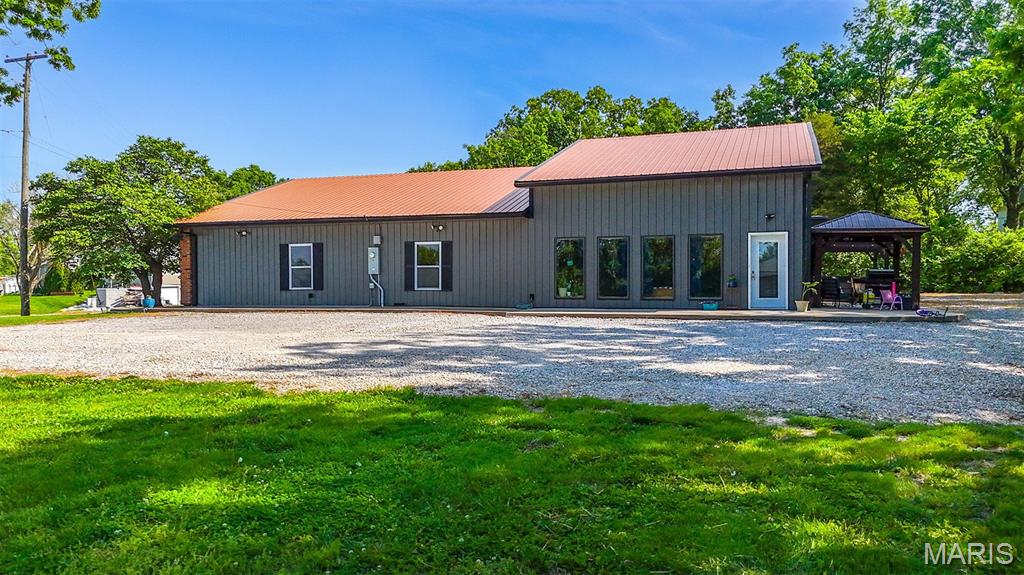Welcome to 1821 N Jefferson Street in Mexico, Missouri! This is a rare opportunity offering the perfect blend of residential comfort and commercial potential on 3.75 acres! This spacious 4-bedroom, 3-bathroom home offers an impressive amount of living space all on the main level with a layout designed for both everyday comfort and entertaining. Inside, you'll find large open living areas, expansive windows that flood the home with natural light, and a warm, inviting feel throughout. The beautiful kitchen serves as the heart of the home with ample cabinetry, great workspace, and easy flow into the main gathering areas. A wet bar adds even more functionality and makes this home ideal for hosting holidays, game days, family get-togethers, or large gatherings with friends. The oversized living spaces and open design create the perfect ''gathering home'' atmosphere while still offering plenty of room for privacy and flexibility. The hot tub conveys, giving you the perfect place to unwind and enjoy the peaceful surroundings. What truly sets this property apart is the additional 1,350 sq. ft. building located on-site. With its own separate electric meter and C1 zoning, the possibilities are endless. Perfect for an owner/operator wanting to run a business just steps from home, the building could also serve as office space, retail, storage, workshop space, or even be leased out to generate additional income. The entire property is zoned C1, allowing for a wide variety of mixed-use opportunities while still providing the comfort and privacy of a residential setting. Properties with this kind of versatility, acreage, and income potential inside city limits are incredibly hard to find. Whether you're an entrepreneur, investor, or simply someone looking for a beautiful home with room to live, work, and entertain, 1821 N Jefferson deserves a look.
