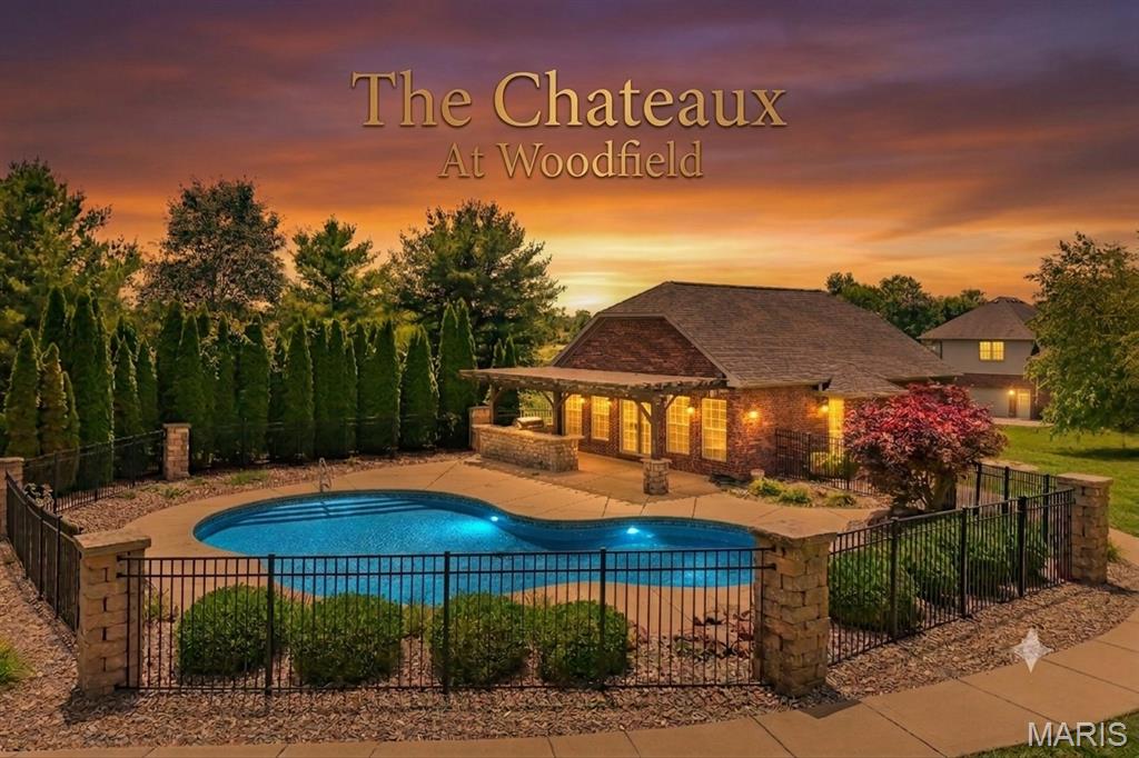 Rare opportunity to own a premium and improved cul-de-sac homesite (Lot 70) in the prestigious Chateaux at Woodfield subdivision.  Purchase separately or with the adjacent luxury residence (Lot 71) for added flexibility Listed on MLS# 26035964.  Property includes a full brick guest house allowing ample space for construction of a future luxury home while enjoying resort-style amenities.   The guest house has nearly 2,000 square feet of living space and has 4 bedrooms, 3 full baths, full kitchen with granite countertops, indoor/outdoor Nuvo audio system, professionally installed security system, custom saltwater pool with waterfall, fully equipped outdoor kitchen, pergola covered entertaining area, professional landscaping, and wrought iron fencing.  Enjoy luxury living at its finest.