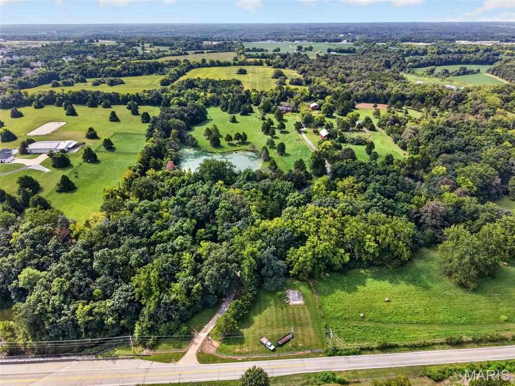 Incredible opportunity to own 30+/- Acres in Unincorporated St. Charles County, just outside of Wentzville City Limits.  The property features a quaint ranch home with good bones, outbuilding, old barn and nearly 2 acre pond.  The property is gently rolling, partially wooded, and offers incredible privacy, just minutes from Wentzville Parkway. With frontage on West Meyer Rd, this property would be great for developers, investors, a family compound, or your own hobby farm close to town. Ideal for 1031 exchange buyers. Come see all this hidden gem has to offer.  Properties this size close to Wentzville are hard to come by and you will not be disappointed.  Schedule your private tour today.