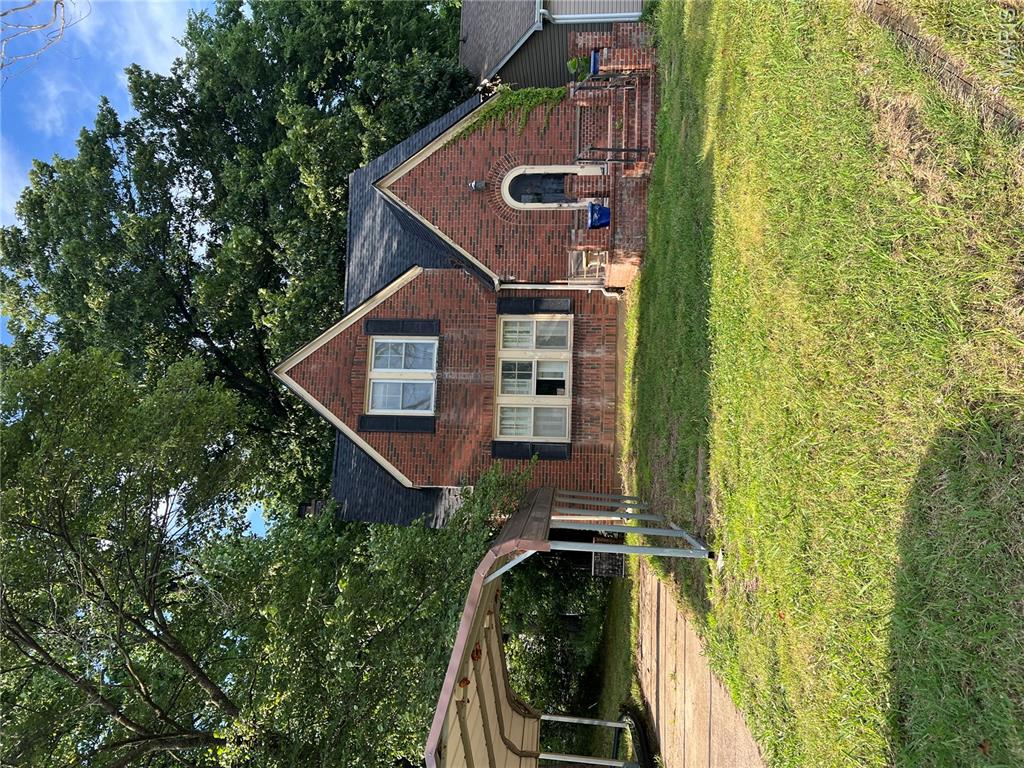 New Roof! Charming brick home, with arched doorways and beautiful staircase. Currently 2 bedrooms, 2 baths, 3 living areas and a sunroom. Nice backyard. With minor changes, could be a 3-4 bedroom home. Needs minimal repairs.
