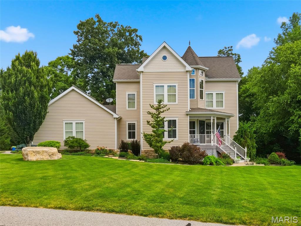 Experience breathtaking views from this beautifully updated three-story Victorian home nestled on 1.76 private acres in the highly sought-after Augusta Shores community. Offering 5 bedrooms, 3 full baths, 2 half baths, and over 3,000+/- square feet of living space, this exceptional property also features an oversized 3-car side-entry garage, a usable level yard and ample space for a future pool. A charming covered front porch and distinctive octagonal foyer create a warm and inviting first impression. The spacious living room showcases hardwood flooring, a gas fireplace, plantation shutters, and direct access to the deck—perfect for enjoying your morning coffee and evening BBQ. The eat-in kitchen is designed for both style and functionality, featuring custom cabinetry, Silestone countertops, a breakfast bar, newer appliances, and a bright bay-window dining area. The main level is completed by a versatile dining room w/ butler pantry, a mudroom w/ custom built-ins and a convenient half bath. The second level offers a spacious primary suite with a walk-in closet and a luxurious en-suite bath featuring dual sinks, a walk-in shower with bench seating, and a freestanding soaking tub. Two additional bedrooms, a laundry room built for a stackable washer/dryer and a full hall bath complete this floor. The third level provides additional living space with a bedroom, recreation room, and half bath—ideal for guests, hobbies, or a private retreat. The 9ft pour on the lower level includes a fifth bedroom w/ cedar closet, full bath, laundry area, and unfinished storage space with endless possibilities. Additional features include an upgraded 50 year rated architectural shingle roof, zoned HVAC system, dual water heaters, an oversized 29 ft. x 27 ft. 3 car garage, whole yard irrigation system, a staircase from the garage to the basement and so much more. Residents of Augusta Shores enjoy resort-style amenities, including two gated entrances, four spring-fed stocked lakes, boat docks, a community pool, tennis and pickleball courts, high speed fiber optic internet and scenic hiking trails. This is a rare opportunity to enjoy waterfront living, privacy, and exceptional community amenities in one remarkable property.