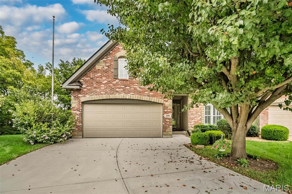Welcome to this beautifully appointed 1.5-story villa in Penny Lane, ideally situated at the end of a quiet St. Peters cul-de-sac and backing to mature trees for a private, peaceful setting. This is one of the best lots in the subdivision! The dramatic 2-story great room makes an immediate impression with a stone fireplace, half-round windows, and custom wrought-iron staircase, complemented by 9' ceilings throughout the main level. Beautiful hardwood flooring flows through the foyer, dining room, and kitchen, adding warmth and character throughout the main living areas. The custom kitchen features a walk-in pantry, new dishwasher, granite countertops, white maple cabinetry, with crown molding, and built-in wine rack. The spacious primary suite overlooks the wooded rear yard and includes a private bath with whirlpool tub, shower, and stained-glass windows. A coffered ceiling and arched openings add architectural detail to the dining room. Upstairs, an open loft overlooks the great room and features an architectural daylight feature providing natural sunlight to this area. Two generously sized bedrooms offer walk-in closets, while the full bath includes a double-bowl maple vanity. The finished walkout lower level expands the living space with a family/recreation room, full bath, workshop, abundant storage, and an ideal area ready to be finished as an additional bedroom if desired. Outside, enjoy the private wooded view from the oversized composite deck or the lower-level aggregate patio. One of these areas will be your favorite spot for morning coffee! Custom details, flexible living space, and a fantastic setting make this Penny Lane villa one you won't want to miss!