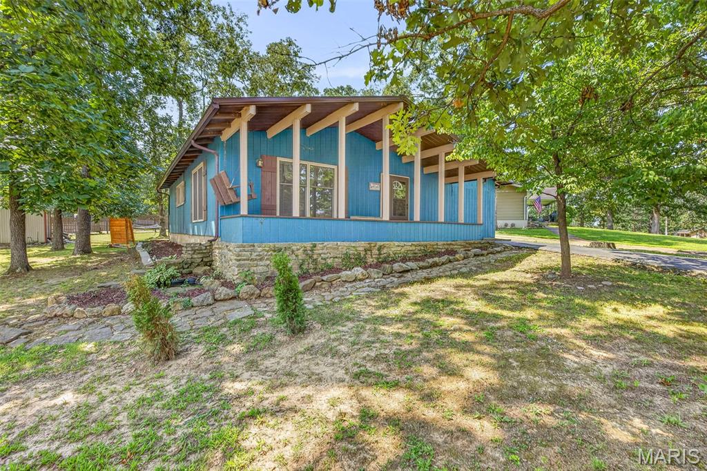 Escape to your own private retreat at 1251 S Deer Run Estates in Fredericktown! This charming 3-bedroom, 2-bath home is in a private lake community, offering a peaceful setting surrounded by the natural beauty of Southeast Missouri. Adding even more value and peace of mind, the home features a newly installed metal roof, remolded master suite, and privacy screens for added privacy to the back yard.  Step inside to a warm and inviting living space highlighted by a vaulted ceiling with exposed wood beams, adding character and rustic charm. Outside is where this property truly shines—enjoy the serenity of beautiful lake view living, beautiful natural surroundings, striking rock formations, and plenty of opportunities to relax, explore and enjoy the outdoors. Whether you’re sipping your morning coffee on the covered porch, spending an afternoon by the water or simply unwinding in the large backyard, at the end of the day, this property offers the kind of setting that’s hard to find. If you’ve been searching for a home that feels like a getaway without giving up the comforts of home, Deer Run Estates may be exactly what you’ve been waiting for. Schedule your private tour today!