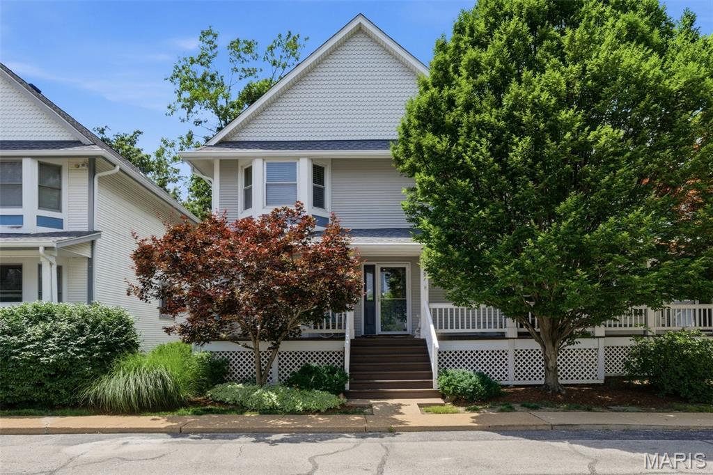 Privacy, convenience, and picturesque views come together in this beautiful home in Webster Groves. Enjoy true low-maintenance townhome living with HOA services that cover exterior maintenance of the roof, gutters, siding, deck, front porch, and landscaping, along with snow removal, trash, and recycling. You’re welcomed by lush landscaping that provides exceptional privacy for the spacious covered front porch. While inside, more than 2,400 square feet of living space provides room to spread out and enjoy. The inviting living room offers a comfortable space to relax, while the family room features built-in shelving, a gas fireplace with new gas logs, and direct access to the dining area and updated kitchen. Quartz countertops, a tile backsplash, sleek black appliances, and open shelving create a stylish and functional space for everyday living. A bonus den offers flexibility as a home office, sitting room, or formal dining room. Step outside to the low-maintenance deck overlooking open green space with no rear neighbors—a peaceful backdrop for morning coffee, evening gatherings, and beautiful winter snowfall views. The upper level features a convenient laundry room and light-filled primary suite highlighted by a bay window, abundant natural light, and an updated ensuite bathroom with a walk-in shower and dual-sink vanity. Two additional bedrooms are served by a well-appointed hall bath, providing comfortable accommodations for family and guests. The finished lower level adds valuable living space and abundant storage. Updates include a new HVAC system (2025), hot water heater (2025), roof (2024), washer and dryer (2024), and dishwasher (2023). Ideally located near Southwest Park, the historic Hawken House, and within walking distance of Clark Elementary, this exceptional home offers the opportunity to enjoy all that Webster Groves is known for, including charming local shops, popular dining destinations, community events, and convenient highway access that makes exploring all of St. Louis effortless.