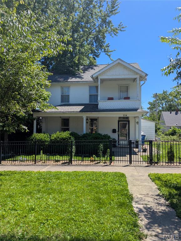 There’s something unforgettable about this home from the moment you arrive. Graceful and gorgeous without feeling the least bit stuffy, this beautifully restored 1864 property wraps historic character, modern comfort, and an incredibly welcoming atmosphere into one truly special place. With more than 2,200 square feet of thoughtfully updated living space, it’s the kind of home that feels both impressive and instantly comfortable.

Inside, sunlight pours through oversized windows into spacious rooms filled with warmth and personality. Original wood floors, high ceilings, custom wainscoting, built-in bookcases, and three stunning fireplaces (two fully functional), create the perfect backdrop for cozy evenings, quiet mornings with coffee and a book, or lively gatherings with friends and family. Every corner feels layered with charm and history while still feeling fresh, stylish, and completely livable.

The oversized dining room was practically made for holidays, game nights, and long conversations around the table, while the inviting living spaces offer endless opportunities for reading nooks, movie marathons, or simply curling up by the fire on a snowy Midwest evening.

The kitchen has been newly refurbished this year and offers a warm, homey feel with all appliances included, plus the washer and dryer stay too, making the move completely effortless. Upstairs, the reading nook next to the primary bedroom opens to a tiny private deck that feels like a hidden retreat for two, perfect for morning coffee, evening wine under the trees, or the best view you can get of the annual downtown fireworks display. You’ll also find access to the enormous attic space, offering incredible storage or future potential.

The third bedroom is tucked through a charming bonus room, creating a flexible layout perfect for a private guest suite, nursery, office, dressing room, art studio, or cozy den. Generous closets, a dry basement, and a detached two-car garage mean storage is never an issue here.

Outside, the covered front porch feels straight out of another era, just waiting for porch swings, friendly conversations, sweet tea, and rainy afternoons. The fenced yard offers even more room to relax and unwind, and don't miss the mature raspberry and blackberry plants tucked into side yard. Full disclosure, that back deck has seen better days, but it's just waiting for someone to turn it back into the outdoor entertaining space of their dreams.

Lovingly maintained and move-in ready, recent updates include a new roof in 2020 along with extensive custom woodwork and built-ins completed within the last five years. This home isn’t just beautiful, it’s soulful. The kind of place where history feels alive, guests instantly feel at home, and everyday life becomes something a little more magical.