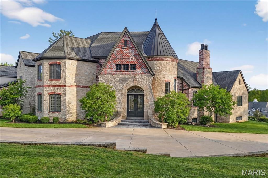If expansive space and sustainable living are at the top of your list, this extraordinary estate delivers. Offering over 9,300 square feet of living space on 3 acres in the heart of Ladue, the home is thoughtfully designed for both everyday living and multi-generational needs, including an integrated in-law suite. Energy efficiency takes center stage in this exceptional EPA Indoor AirPlus Qualified Home, thoughtfully engineered for both sustainability and superior indoor air quality. Solar panels harness renewable energy to meaningfully offset utility expenses, while an advanced geothermal heating and cooling system delivers remarkably efficient, even-temperature comfort year-round. Complementing these systems is a water filtration system that supports a cleaner, healthier living environment. Together, these high-performance upgrades create a home that prioritizes sustainability, cost savings, and elevated everyday comfort — a rare combination of environmental responsibility and refined living. A grand entry hall welcomes you with a dramatic two-story curved staircase. The wood-paneled great room serves as the heart of the home, showcasing soaring ceilings, a fireplace, and French doors opening to the patio. The formal dining room easily accommodates large gatherings, while the expansive kitchen impresses with abundant cabinetry, a center island, oversized walk-in pantry, and a Butler’s pantry/prep kitchen. The main-level primary suite features a generous walk-in closet and a spacious bath with separate vanities and dual water closets. Positioned on the opposite wing of the home, the main-level in-law suite is thoughtfully designed with its own private kitchen, ensuite bath, walk-in closet, and dedicated thermostat. Handicap-accessible and exceptionally well-equipped, it provides comfortable, independent accommodations ideal for extended family or long-term guests. The second floor features three ensuite bedrooms and a generous bonus room that can serve as a sixth bedroom. The finished walk-up lower level is designed for entertaining, complete with a wine cellar and tasting room, game room, recreation room, two bathrooms, and additional kitchen and laundry. A four-car garage provides ample space for vehicles and storage, completing this exceptional Ladue property.