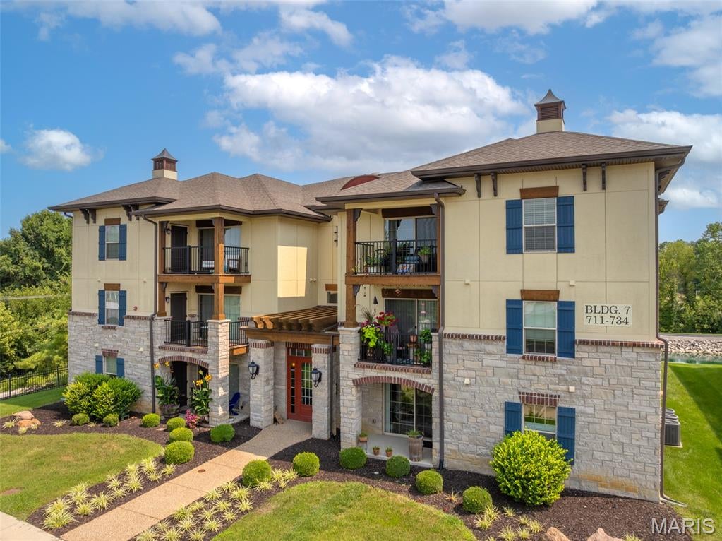 Impressive 2 bedroom, 2 bath corner garden condo in the desirable Bordeaux Condominiums - almost 1,260 SF! FHA SPOT APPROVAL financing as an option!  Step inside to find LVP flooring throughout the main living areas, easy care and style. Most kitchen appliances are just 2 years old, and the washer and dryer — 2024 models — are included in the sale. Brand new HVAC Unit and condenser unit installed in August 2026. Enjoy 1,254 SF of open living space, not counting the private balcony with composite decking where you can look out over the neighborhood walking trail, fountained pond, and adjacent Woodlands Park. The floorplan features split bedrooms for privacy, main floor laundry, and an open kitchen, dining, and living room. The primary bedroom and bathroom are both spacious, and the walk-in closet comes with built-in shelving. The monthly fee covers water, sewer, trash, snow removal, and exterior maintenance. This sale also includes covered parking spot #14, plus plenty of open parking. Live where the fun is! Can rent this to a family member according to the HOA. Close to charming downtown Cottleville you’ll have easy access to local shopping, restaurants, entertainment, and community events. This move-in ready condo offers the perfect blend of modern amenities, low-maintenance living, and an unbeatable location. You won’t find a better deal for the square footage and condition — schedule a showing today!