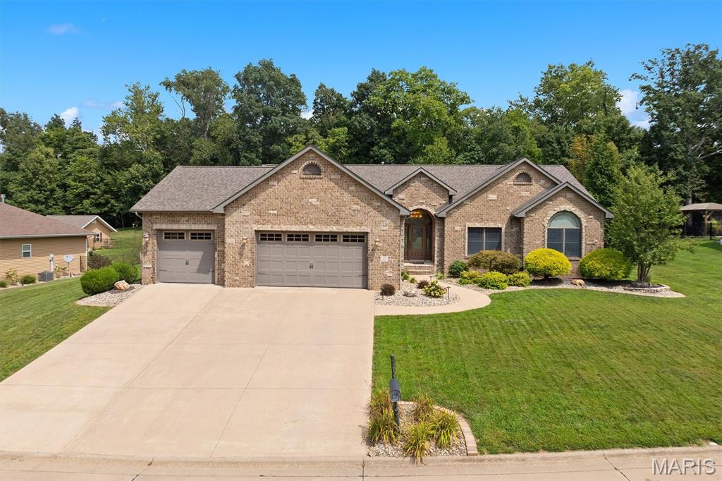 Tucked away on the NW side of town you will find one of Highland’s best kept secrets – Liberty Hills Subdivision. Welcome to 55 Liberty Lane, a beautifully custom-built 5BR, 3.5BA ranch home offering amenities that are sure to check all the boxes! As soon as you enter the home you will be captivated by the open concept floor plan featuring cathedral ceilings accented by custom beams and exquisite hickory hardwood flooring throughout. The spacious kitchen includes abundant cabinetry, a large center island, granite counter tops, stainless steel appliances, a beautiful glass backsplash, and large walk-in pantry. The dining area offers generous space for entertainment and includes a spectacular view of the property visible through upgraded custom patio doors. The great room is enhanced by a floor to ceiling gas FP and mantel, Anderson windows, and a magnificent arched entry doorway which adds charming character. On the main level you will also find 3BRs and 2.5BAs. The primary suite offers large bath with dual sinks, jacuzzi tub, separate shower and walk-in closet.
The finished basement offers an additional 2BRs and 1BA and huge recreational space including a Weis Woodworking custom entertainment center with 86” TV, Yamaha stereo/receiver, and Jamo speakers and sub-woofers for an incredible media experience. The 15ft wet bar features two-tier waterfall granite counter tops, glass shelving, a “hidden TV” with amp and two additional speakers, Sharp microwave, Fisher & Paykel dishwasher and KitchenAid Triple-Zone refrigerator. Also included are a 20ft Champion Worthington shuffleboard table and electronic dartboard for hours of enjoyment. Additional indoor features include Beam central vacuum, HEPA whole house air filtration system and full-time hot water circulation for instant hot water availability. Outdoor features include 7-Zone Hawkeye Irrigation sprinkler system, Slemmer Landscaping and lighting, 12’ x 16’ utility shed with loft, and a patio with granite BBQ, storage, electricity and lighting. All of this is topped off with a new roof in 2025! A truly distinctive home with quality finishes, custom features, and abundant living space.