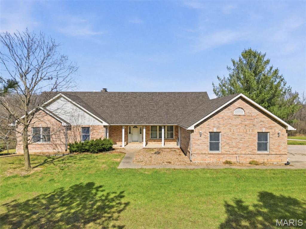 Spacious ranch home situated on 4.99 acres, offering the perfect blend of comfort, functionality, and country living. Recent major updates include a brand-new roof and new HVAC system with a transferable 10-year warranty, providing peace of mind for years to come. The main level features 3 generously sized bedrooms, 2.5 bathrooms, and a vaulted living room centered around a stunning full masonry wood-burning fireplace. The kitchen offers solid surface countertops and is complemented by both a formal dining room and a breakfast area. Main floor laundry adds everyday convenience. The partially finished walk-out basement provides additional living space, including a media room, recreation room, den or potential 4th bedroom, a full bathroom, and abundant storage space. Enjoy the outdoors from the elevated deck overlooking the property or the lower-level patio, perfect for relaxing or entertaining guests. Additional improvements include a 3-car attached garage and a 25' x 46' shed/barn, offering exceptional space for storage, hobbies, livestock, or equipment. A rare opportunity to own nearly 5 acres with versatile outbuildings, updated mechanicals, and plenty of room to live, work, and play.