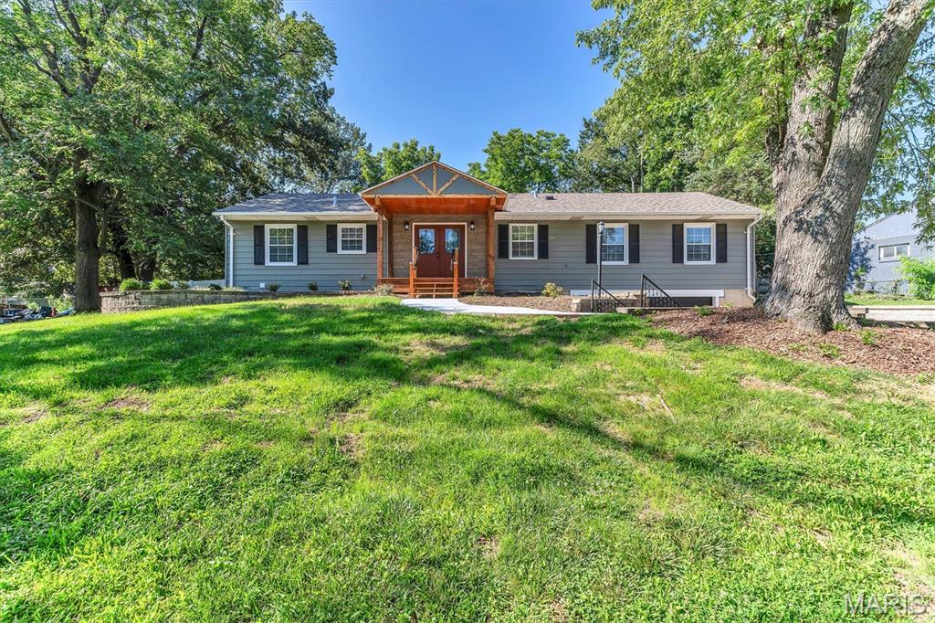 This beautiful 4 bed 3.5 bath renovation is in a fabulous location in a transitioning neighborhood where home values can exceed 700k! Situated in Rockwood schools on an over 1/2 acre lot that has a 6 foot privacy fence in the back yard. Custom tile work abounds in all bathrooms, new flooring, lighting and gorgeous white shaker cabinets with custom backsplash in the kitchen. New appliances including a beverage cooler and a newer refridgerator that was existing. Two bedroom area with its own entrance plus spacious bathroom and double sinks. Huge Primary bedroom with ensuite bath, walk in closet that has a stackable laundry option plus a laundry closet in the basement. Cozy family room with a wood burning fireplace and sliding door to the backyard patio. Additional bedroom in the basement with large double sink bathroom and a finished recreation area. This home won't be available for long and you get alot of bang for your buck! Get into this neighborhood while you can at this price!!