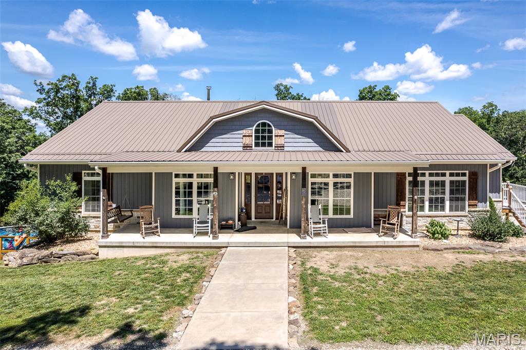 Wow!!   They weren't planning on moving when they built this one!!   Its beautiful and its done right!!  5 bedrooms, 4 bathrooms, woodburning fireplace, cathedral ceilings, nice wood floors, attractive farmhouse style decor, split bedroom plan, chefs dream kitchen, huge laundry room with lots of storage and shelving, and a full partially finished basement.   And, it walks out to a private cool spot for entertaining, pool and all!!  Also, it is located on almost 10 wooded acres yet still just a few minutes from town!   Wait until you see the trail cam pictures!  Lots of wildlife and huge deer!!  There is so much you're going to love about this place!  Don't wait!