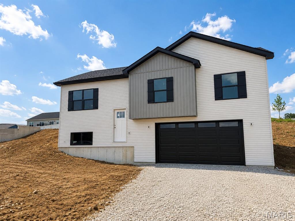 COMING SOON! HOME IN PROGRESS! #UNIONMO.  A VERY SPACIOUS MULTI-LEVEL HOME TO FALL IN LOVE WITH!! Under Construction NOW. A Quality New Construction home with so much to offer. This is the type of floor plan that provides a lot of bang for the buck. A very stylish multi-level design featuring great curb appeal with pewter siding, gray shaker siding in the bump-out, black board & batten shutters, wide driveway, gorgeous front door, composite deck front porch, & more. Home comes equipped with a 2 car oversized garage, nice lawn, rear patio, front porch, 4 beds x 3 full baths, plenty of sqft, a large living room with 9' Ceilings, an elegant ceiling fan, LVP flooring, a spacious kitchen with plentiful white cabinets & a sleek granite countertop design, built-in dishwasher & microwave, a single door with half glass with built in blinds to the rear patio, etc. The grand primary suite includes a walk-in closet, a large white double-bowl vanity, and a shower. A large Lower Level 4th bed with entry landing from garage, having a nice closet for coats & shoes, laundry/storage area & a third full bath.  ELS HOMES - LOCAL BUILDER AT ITS FINEST - #ELSHOMES