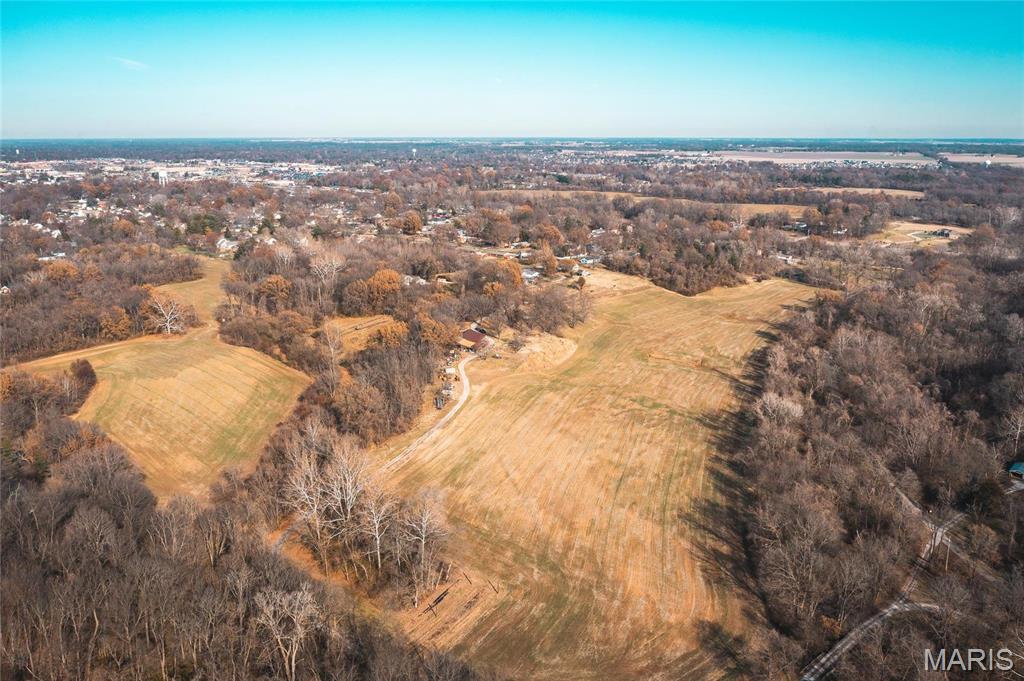 EXCLUSIVE HIDDEN GEM right in the heart of Edwardsville Township.  This 50+/- beautiful acres is a family legacy just now coming available for the first time in generations formerly used as a private farm including up to 50 head of cattle.  This extraordinary land boasts rolling hills, timber, pond, deer, access to the MCT bike trail, privacy, seclusion and more just 1 mile from all the shops, eateries, services and growth that Edwardsville has to offer.  There are several plotted access points to this property making it an excellent location to build a luxury home or several large lots for the family or even larger residential development.  Electricity is on the property and all other utilities are at the property line.  Schedule an appointment to tour this property today.