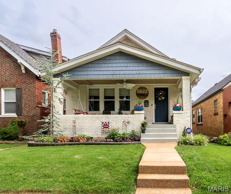 Cozy but roomy home in SOHA's popular neighborhood for walkability to all things including Macklind Ave shops, restaurants, grocery stores, Hampton Village and  Francis Park. Make it a habit to walk your dog along the tree-lined streets and enjoy SoHa summer nights events or sit and watch the neighbors pass by on your large covered porch. This home looks like a bungalow on the outside but is actually a spacious 4 bedroom 3 bath home with 2500+ square feet with updated high-end finishes. The Sunroom is currently used as breakfast room but could be painting or hobby room with the view of your private backyard as the backdrop. Or head out down the composite stairs to and sit under your pergola w/ cafe' lighting. The fenced-in yard has a crisp modern aesthetic with turf grass framed by flowers and natural plants. 2-car detached garage leads from alley way to back yard. The recently finished (2024), professionally designed, primary suite spans over 500 sq ft featuring wide vinyl plank flooring. It includes an expansive walk-in closet w/built-in bench, full bath completed with space saving pocket door and small sitting area. Kitchen remodeled 2022 w/canned lighting 42 inch cabinets granite counters and breakfast bar open to the sunny family room. Finished LL has been completely waterproofed and has walk-out access along with 4th bedroom, recreation room, and nice full bath. This is a well-cared for and loved home w/rich history ready for a new chapter.