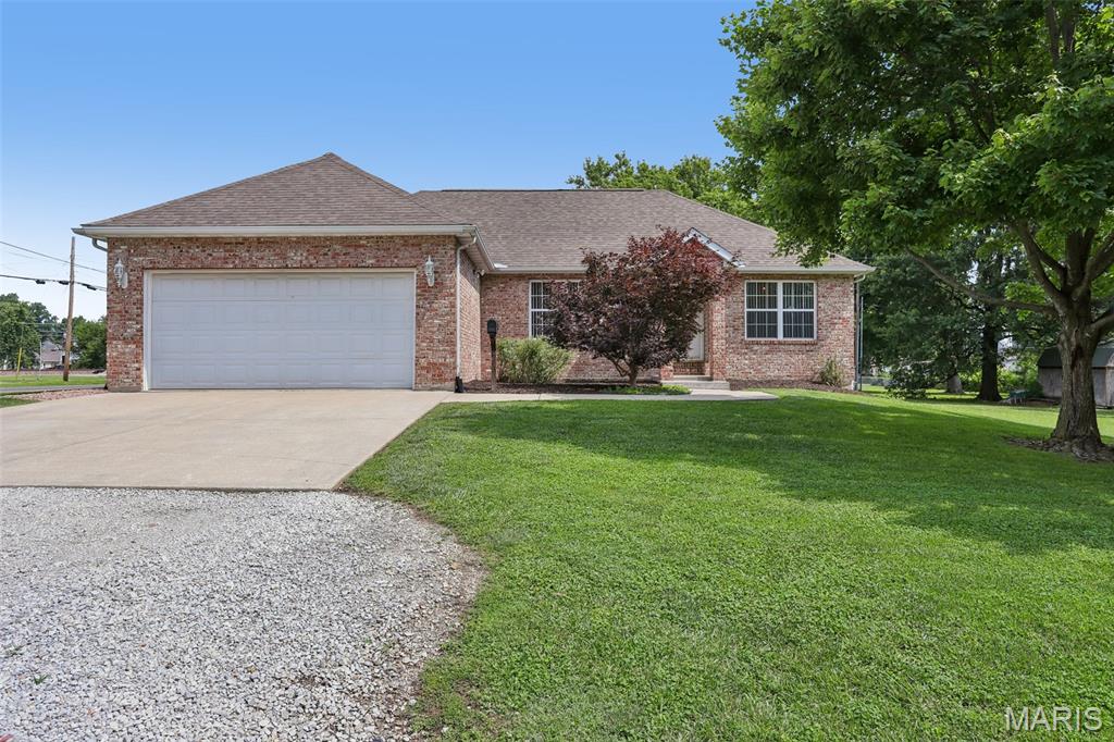 Set on a corner lot with a vinyl-fenced yard, this well-kept home offers comfortable, easy living with a smart split floor plan. The open living, dining, and kitchen area creates a great flow for everyday life and entertaining, while a cozy sitting area features a ventless gas stove with a decorative flue—a warm focal point you'll appreciate year-round. The kitchen anchors the space with a center island and plenty of room to gather. A sunroom and mudroom/laundry add everyday function, and the primary suite includes its own bath and closet for added privacy. Major comfort items are in good shape, with the furnace and AC just three years old. Outside, enjoy a back deck and an above-ground pool—perfect for summer days in the fenced yard. The attached insulated garage, carport and full unfinished basement, already roughed in for a future bathroom, offer storage and room to grow. A solid, move-in-ready home with great bones and thoughtful updates.
