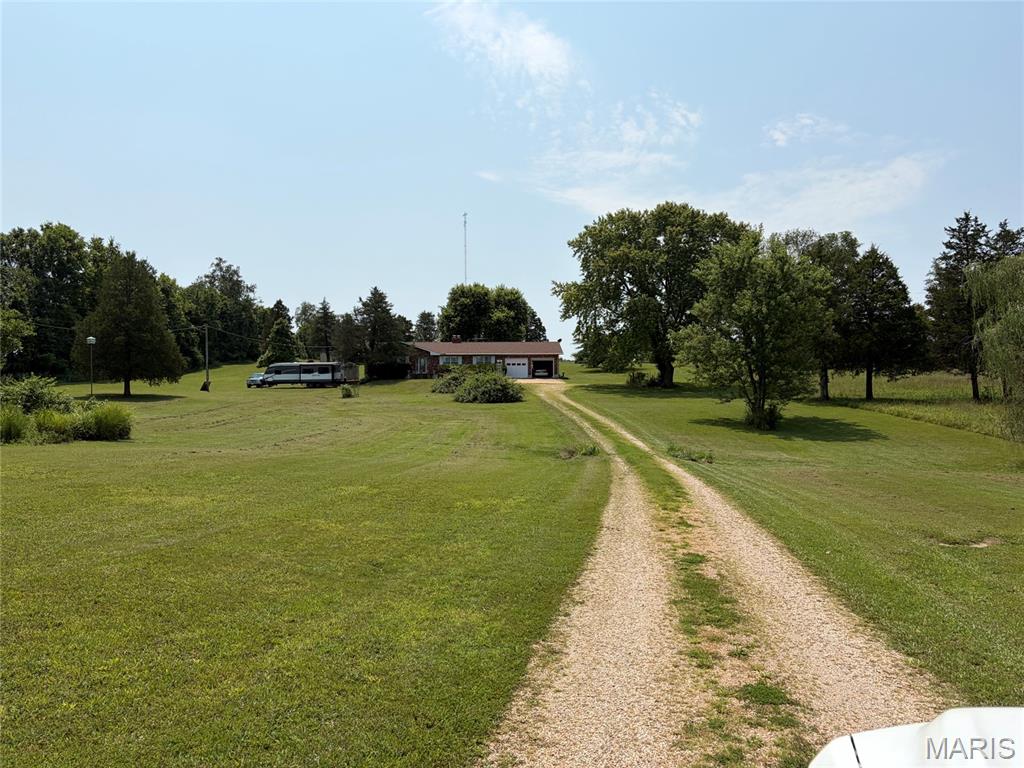 Fantastic Brick home with walk-out basement on 9.35 acres in North St. Francois County School District.  Enjoy the storage in the 30x40 barn with electric garage door opener, heater, and 30 amp service for your RV.  Wood burning fireplace in family room upstairs.  Huge walk-in pantry off kitchen.  Also features a sunroom and fenced area for pets or children to play safely.  Closets are cedar lined.  Second kitchen in the basement plus another fireplace! Laundry room has a shower/tub and commode; easily could be finished into a third bath.