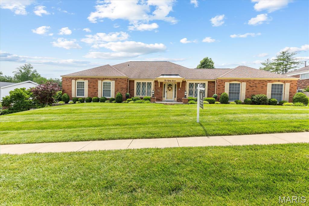 Welcome to this beautifully maintained and spacious brick ranch in sought-after Westbury Manor! Prime location just a short walk to the neighborhood pool! Exceptional curb appeal shines through the stunning landscaping and inviting brick accent columns at the front porch. Inside, you’ll love the open floor plan, custom built-ins, and numerous updates that reflect true pride of ownership.  The light-filled family room offers a warm and inviting atmosphere and flows seamlessly into the gourmet kitchen, fully renovated and expanded with custom cabinetry, granite countertops, high-end stainless steel appliances, and abundant workspace and storage. The impressive primary suite has been thoughtfully expanded and reconfigured to include a huge custom walk-in closet by The Closet Factory, large windows for abundant natural light, and a beautifully updated en-suite bath featuring a separate shower, makeup area, and spacious granite vanity. Two additional bedrooms are generously sized, each with ceiling fans, and share a renovated bath with a stunning granite vanity. From the kitchen, an expanded sliding glass door leads to the lovely patio and beautifully landscaped with irrigation system, level backyard complete with landscape lighting and 2 motion lights, extensive stonework, and a gorgeous retaining wall that adds both beauty and functionality.
The fully finished lower level provides exceptional additional living space, featuring a custom bar, expansive recreation/family room ideal for entertaining, a full bath, and two bonus rooms perfect for an office, guest space, or playroom. One bonus room features a full-sized window with wonderful natural light, while the other showcases a unique glass wall design. The oversized finished laundry room offers incredible storage, built-in shelving and cabinetry, plus ample space for hobbies, crafts, or a workshop area. Heating is provided by a gas furnace throughout the home, supplemented by a separate electric furnace in the basement for added comfort during severe winter temperatures. The garage features a dedicated work area and professionally finished flooring.  The lot offers a prime location just a short walk from the fabulous neighborhood pool. Located within the highly acclaimed, award-winning Parkway School District, this home is also centrally situated near shopping, dining, entertainment, and downtown attractions.