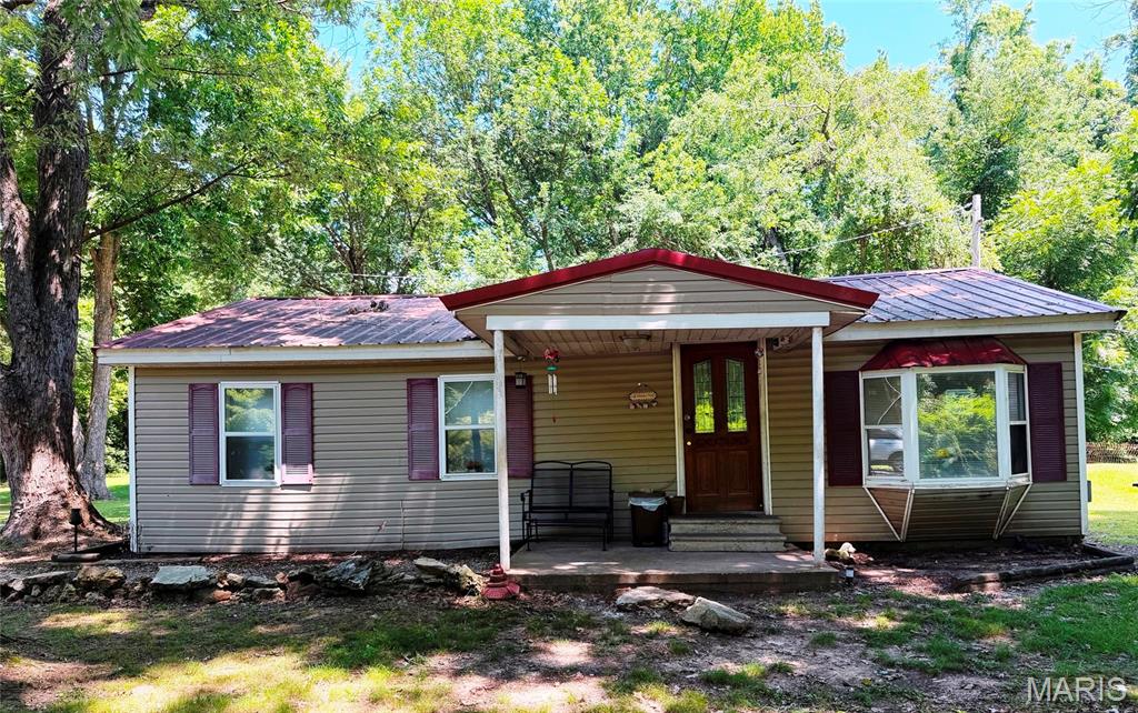 Nice 2 bedroom, 1 bath, ranch home setting on 2 acres in a beautiful park like setting with mature shade trees. House has vinyl siding and a metal roof.  Property Includes a large, detached garage (30 x 24) with metal siding, metal roof,  overhead garage door, passage door and concrete floor. It is wired for electric.  Also includes a storage shed.    Main floor Laundry; Concrete patio; Covered front porch.  Concrete septic tank.  Pumped in 2024.  Seller is selling "As Is".  Will make no repairs.   Call now for your personal showing.