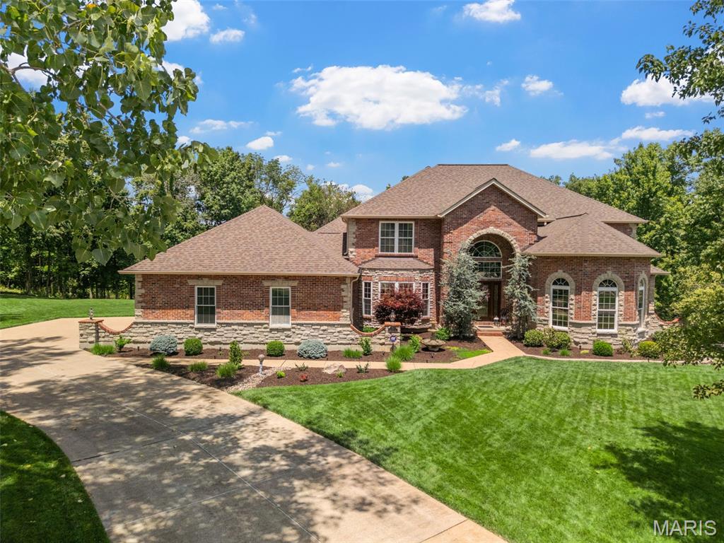 Situated within a cul-de-sac & on 1.25 acres in the Lindbergh district, this custom-built home offers 6,000+ sq ft of luxurious living space designed for both elegance & everyday comfort. The main level features a spacious primary suite w/ a spa-like bath, curved staircase, tall ceilings, hearth room w/ frplce, DR, & home office. The kitchen includes newer Quartz counters & newer stainless appliances, along w/ a butler’s pantry & convenient back staircase leading to the 2nd level. A dramatic 2-story great room w/ a stunning wall of windows & a 2nd frplce fills the space w/ natural light & warmth. Upstairs, you'll find 3 generously sized BDRMS, 2 full BAs, & a large loft area that offers flexible space for a playroom, media lounge, or study zone. The Finished W/O LL expands your living options even further w/ a  family room & 3rd frplce, kitchenette, rec area, 5th BDRM, full BA, & dedicated media room. And oh the storage area - so much space! Outside, the level backyard lined w/ mature trees offers privacy  complete w/ a custom patio, pond, & a maint-free deck perfect for relaxing or entertaining. Additional highlights include an O/S 3-c. gar., central vac, in-ground sprinkler, 3 water heaters, 3-zone HVAC systems ('21), newer roof ('20), & some brand-new carpet. With a versatile layout, quality finishes, & a serene setting, this home blends size, style, & functionality is extraordinary! 1 owner home that has been smoke & pet free! Home inspection & home warranty included!