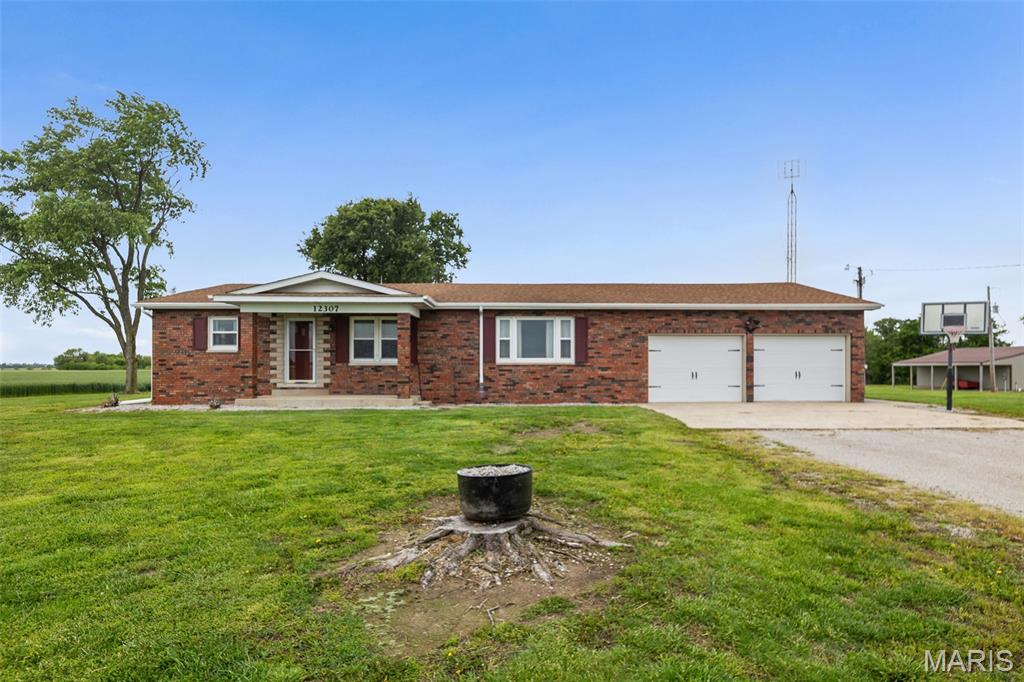 Welcome to this peaceful country retreat just outside of Nashville Illinois! Situated on approximately 3.66 acres, this charming full brick home has 2 bedrooms on the main floor and 2 living spaces, a very large kitchen with dining area, a large hall bath with walk-in shower and a half bath near the over sized 2 car garage and back entrance.  The basement has a wet bar/cooks kitchen in the recreation room area and an additional room suitable for crafts or office.  This home offers the perfect blend of rural privacy and everyday convenience. Built in 1969, the property features over 1,500 square feet of living space with a functional layout, offering ample room for storage, hobbies, or future expansion.   There is a barn, a workshop and a newer metal pole barn building with sprayed on insulation.  The mower shed near the house does not stay.  The 2 Silo bins are rented to local farmers.  
Enjoy wide-open views, mature trees, a pond and plenty of outdoor space for gardening, recreation, or simply relaxing in the quiet countryside. Whether you're looking for room to spread out, start a hobby farm, or enjoy small-town living with easy access to town amenities, this property delivers endless possibilities.
With its scenic setting, acreage, and classic country appeal, 12307 County Highway 27 is a rare opportunity to create the lifestyle you’ve been dreaming of. Schedule your private showing today!