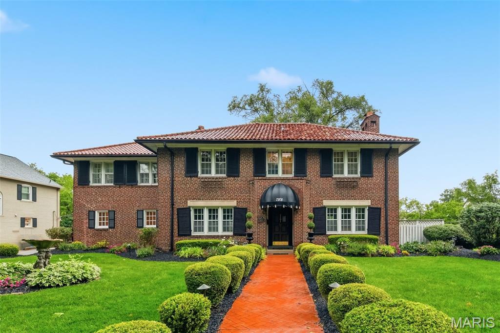 Nestled in the heart of sought-after University City this stately brick residence blends timeless architecture, historic charm, and an unbeatable central location. Offering nearly 3,000 square feet of living space above grade, this grand home welcomes you with classic elegance, rich character, and beautifully preserved details throughout. Inside, you’ll find stunning historic features including terrazzo floors, gracious room sizes, handsome millwork, and the warmth and craftsmanship rarely found in newer construction. The flexible floor plan offers 4 bedrooms and 3 full bathrooms, with one of the bedrooms currently transformed into a stunning custom walk-in closet designed by St. Louis Closet Company. Thoughtfully crafted with exceptional organization and storage, this luxurious space can easily be converted back to a traditional bedroom if desired, offering flexibility to fit your lifestyle. One of the home’s most distinctive features is the expansive second-floor great room/sunroom—an incredible extension of the living space bathed in natural light. Surrounded by windows and filled with warmth, this inviting retreat offers endless possibilities as a family room, reading lounge, office, creative space, or peaceful escape. Adding to the home’s functionality and convenience, the second floor also features a dedicated laundry area complete with a brand-new stackable washer and dryer set that will remain with the home. Outside, the extensive gardens and manicured grounds create a private storybook setting, perfectly complementing the home’s stately curb appeal. Whether enjoying morning coffee surrounded by lush landscaping or entertaining on warm summer evenings, the outdoor spaces feel both peaceful and refined. Ideally situated adjacent to Lewis Park and just moments from Washington University, the Delmar Loop, and neighborhood favorite Winslow’s Home, this location offers the perfect blend of walkability, culture, dining, and convenience. A rare opportunity to own a truly charming and architecturally significant home in one of University City’s most beloved neighborhoods.