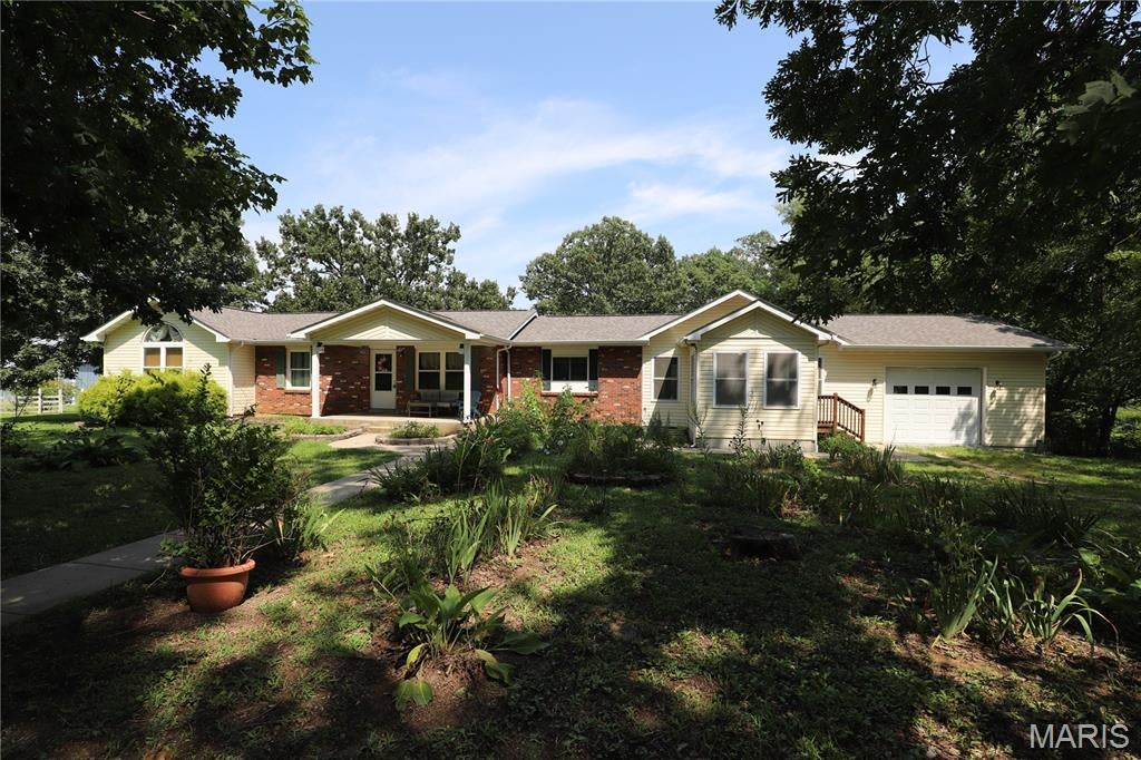 Experience the perfect balance of privacy, comfort, and country charm on this exceptional 5.43-acre property. Surrounded by beautiful scenery and thoughtfully designed for both everyday living and outdoor enjoyment, this one-of-a-kind home offers space to relax, entertain, and pursue your favorite hobbies.
Inside, you'll find more than 2,200 square feet of well-appointed living space featuring custom details throughout. The spacious kitchen is the heart of the home with custom cabinetry, a large center island, pantry, gas range, and plenty of room for gathering. A bright sunroom showcases peaceful views of the property, while the inviting family room with a gas fireplace creates the perfect place to unwind. The welcoming foyer, custom built-ins, and main-floor laundry add both style and convenience. The generously sized primary suite features two walk-in closets, and the partially finished basement provides flexible space for a recreation room, home office, guest area, or potential third bedroom. Step outside and discover everything this incredible property has to offer. Spend evenings on the covered deck with its outdoor fireplace overlooking the approximately one-acre stocked pond. This property has peach, pear and apple trees on it. Garden enthusiasts will appreciate the greenhouse, while horse lovers and hobby farmers will love the impressive 46' x 18' barn complete with two horse stalls, tack room, workshop, and storage space. An additional 40' x 40' barn offers endless opportunities for equipment, recreational vehicles, livestock, or workshop space. Whether you're looking for a peaceful retreat, room for horses, or a property that offers the freedom to enjoy country living without sacrificing convenience, this remarkable Bismarck property is ready to welcome you home. Don't miss your opportunity to make it yours!