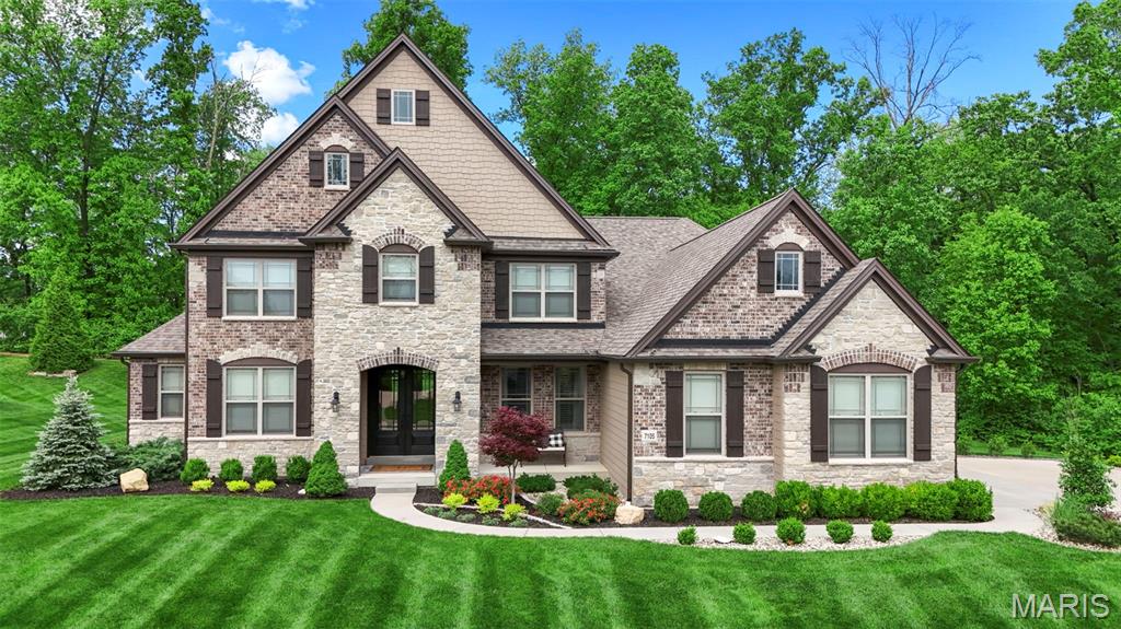 Every detail of this Lombardo-built home in prestigious The Bluffs at Windcastle was
chosen w/ purpose, precision, and pride of ownership. Set on a quiet street
that ends in a wooded cul-de-sac, this home greets you each evening w/ a perfectly lit
landscape, custom lighting, & an extended driveway framed by lush, professionally
planned plantings. Pull into a fully finished 3-car side-entry garage w/ sealed floors,
custom walls, & newer insulated doors. On a street called Castle Cliff, the name fits!
The custom exterior of brick, stone, Hardie Board, & cedar shake is accented by
custom shutters, exterior & holiday lighting, extensive landscaping, & a 15-zone
irrigation system that keeps every inch looking its best. Step through
custom double front entry doors into 5,563 square feet of carefully crafted living space
spanning 3 levels. 2Sty ceilings, custom arched architectural details
throughout, solid-core interior doors, recessed lighting, hand-scraped wood floors, & a
whole-home speaker system managed by Control4 smart home automation sets the
standard from the start. The Great Rm centers on custom-built-ins flanking an
upgraded gas fireplace w/ stone surround, raised hearth, & wood mantel. Above,
a motorized chandelier lift lowers w/ the flip of a switch for effortless maintenance, one
of many forward-thinking details this home was built with. Custom open staircases w/
stained handrails, box newel posts, & half-inch metal balusters connect all 3
levels w/ architectural consistency, + a custom Juliet balcony at the upper Loft
overlooks the Great Room below. The main-level Study features custom french doors & sculpted ceiling, offering the perfect work-from-home space. The chef's Kitchen is designed w/
workflow in mind & is anchored by an elegant stone archway: 42" cabinetry,
quartz countertops, upgraded gas range, pot filler, custom sink, and a
separate control center & walk-in Pantry that keep the daily mess out of sight! The adjoining Sunroom, w/ it's custom trey ceiling & sliding glass door, brings the outdoors in year-round, a combination that makes this Kitchen truly the heart of the home. A main-level Laundry Room with a utility sink adds everyday practicality to daily
living. The main-floor Primary Suite is an owner's retreat. A bay window frames the wooded
backdrop & the luxury Bathroom, w/ a freestanding soaking tub and an oversized
shower - is giving spa bath vibes! Adult-height dual vanities, a huge customized
walk-in closet w/ its own laundry hookups, complete the experience. Upstairs, you’ll
find 3 additional Bedrooms, a private en-suite, and 2 share a well-appointed
Jack-and-Jill Bathroom. The upper-floor Loft/Family Room is a bonus just off the
Bedrooms. Downstairs, the finished lower level features a deep-pour foundation, making it an
entertainer's domain.  A full wet bar and the dedicated Home Theater, with an entertainment wall and built-in surround sound, deliver a private cinema experience without leaving home. Additionally, a Rec Room & full
Bath round out the space. Step outdoors to a rear patio, which opens to a backyard that earns
the word private. The lawn is lush and completely out of view, with a setting that lets you forget the rest of the world exists. Tucked in the back is a custom flagstone fire pit area with mood lighting and outdoor speakers serving as a secret escape. A 220-volt circuit is already roughed in on the rear of the house for a future hot tub or pool. Enjoy effortless seasonal curb appeal with exterior outlets seamlessly integrated into the Control4 automation system so you can turn your holiday lights on and off with ease. Just minutes from Whitmoor Country Club, Missouri Bluffs Golf Club, Old Hickory Golf Club, & Persimmon Woods Golf Club. The Katy Trail is a short drive, close to Highways 40 and 364 for easy commutes. Top-rated Francis Howell R-III.  Cottleville dining and retail, nearby hospitals, & Chesterfield Valley is just across the bridge!
