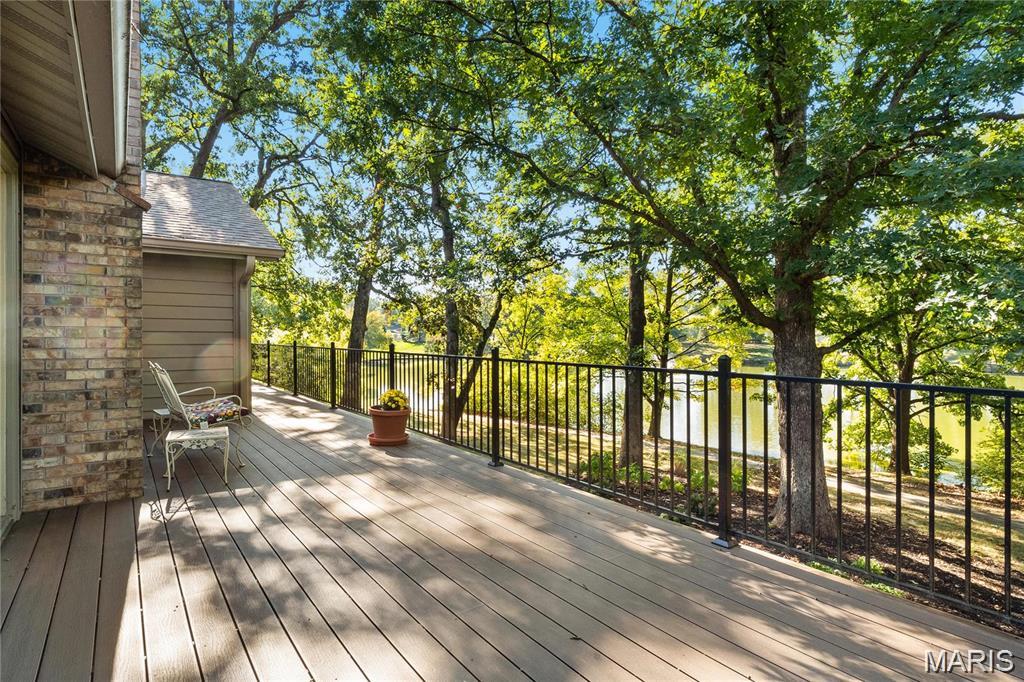 Discover a rare sense of peace in the heart of Town and Country. Nestled among mature trees in the sought-after Pinetree Lake Subdivision, this distinctive ranch offers three bedrooms, three full bathrooms, one half bathroom, an oversized garage, and beautiful lake views that create a calming backdrop for everyday life.

Imagine beginning the morning with coffee on the expansive composite deck as sunlight filters through the trees, or ending the day listening to the fountain and watching the water from your own backyard. This picturesque setting offers a wonderful connection to nature and a feeling of privacy, tranquility, and harmony that is difficult to find.

Inside, the spacious great room makes an immediate impression with its vaulted ceiling, exposed beams, brick fireplace, and access to the deck. The refreshed kitchen features quartz countertops, white cabinetry, a center island, double ovens, a microwave, a Bosch dishwasher, and a generous dining area overlooking the wooded surroundings.

The walkout lower level expands the home’s possibilities with an additional fireplace, a wet bar, a full bathroom, and flexible space for entertaining, relaxing, working, or creating a private retreat. Step outside to the covered patio and enjoy another peaceful vantage point overlooking the lake and shaded yard.

Recent improvements include a new roof in 2025; new primary ensuite, wood floors, and replacement of major plumbing stacks in 2022; refreshed kitchen finishes, quartz countertops, newer appliances, insulated vinyl siding, interior painting, refreshed lower-level bathroom, and new exterior lighting in 2021; furnace and refrigerator replacement in 2019; and a custom composite deck completed in 2018.

Located in the Parkway Central High School area, this charming home combines an exceptional Town and Country location with a truly special lake setting. Move in and enjoy its warmth today, then add your own personal touches to make it entirely yours. 
Professional photos should be uploaded tomorrow. Make your appointment showings should start August 21, 2026 after 4 pm.