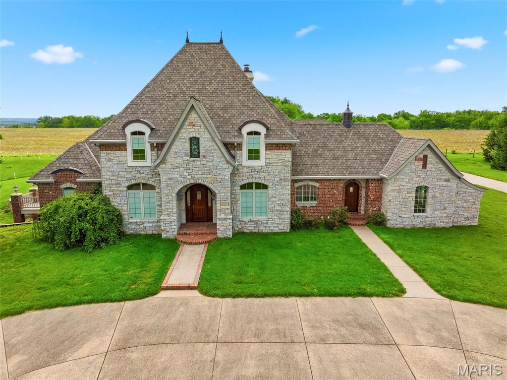 In my opinion THE BEST property in Elsberry w/ 20 acres of sprawling land(approx. 100 more acres available), a beautiful home that represents luxury living at it's finest including an elevator that reaches all 3 floors. Beautiful views from every direction with fenced pastures and panoramic views. The long driveway leads you to incredible views, this property has been in the family for many years. As you approach the property w/ a circle drive you will notice the stone front elevation w/ brick on all 3 other sides, a new arch. roof done in 22, geo thermal, 3 HVAC, 2 hwh, the entire home is wheelchair accessible with an elevator that reaches all 3 floors. This unique home has 12 doors leading to the exterior on the main level alone as well as a finished walk out LL that is incredible. There is even an in-ground pool on the main level, the kitchen is truly a chef's delight w/ double ovens, a warming drawer, built in refrig., built in cooler, 2 dishwashers, huge island w/ seating and a beautiful bay window overlooking your private yard. The home has detailed crown molding t/o, 5 in. baseboards, custom door cases and top of the line lighting including Swarovski crystal chandelier in the dining room. The dining room and study have wood floors and detailed wood work. The great room is open to both w/ a gas fireplace. The primary suite is off of the great room and is huge and also offers a sitting room area, a door that leads to your own private deck, the primary bath has a hidden closet, large walk in closet w/ custom shelving and cabinets, large walk in shower w/ seating, large soaking jacuzzi tub and of course double sinks w/ granite counters and heated tile floors. Upstaris you will find a large loft with triple doors leading to a covered balcony that is screened, 2 large bedrooms w/ walk in closets w/ built in organizers and a jack and jill bath.
This home has so many storage rooms and closets it is incredible. It really is an incredible well built home, the seller went above and beyond with this custom built home and a lucky buyer will enjoy this home for many years to come.   

Once in a lifetime opportunity to own this unique property that also offers another listing that   Includes 3 underground limestone mines with 49 acres as well.  There is also opportunities to buy more land w/ barns, pastures and a pond. Perfect location w/ convenient access to Hwy 79 & approx. 25 minutes to HWY 70.