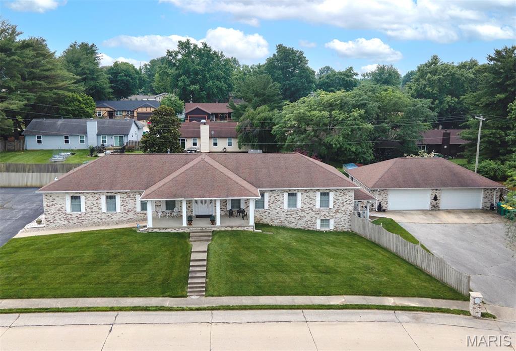 Discover the incredible potential of this all-brick, multi-use commercial building located in the heart of O’Fallon on a high-visibility corner lot. Formerly a chiropractic office, the main level is thoughtfully divided into multiple rooms, including one specially constructed with solid walls to accommodate an X-ray machine—ideal for medical or diagnostic purposes. The spacious layout makes this property perfect for a wide variety of opportunities such as a daycare, medical facility, or professional office space. The building also features a full basement with a living space, offering a unique live-work arrangement. A large detached garage and ample off-street parking enhance the convenience, while the prime location ensures excellent exposure to daily traffic. This is a rare opportunity to own a versatile property in a thriving area!