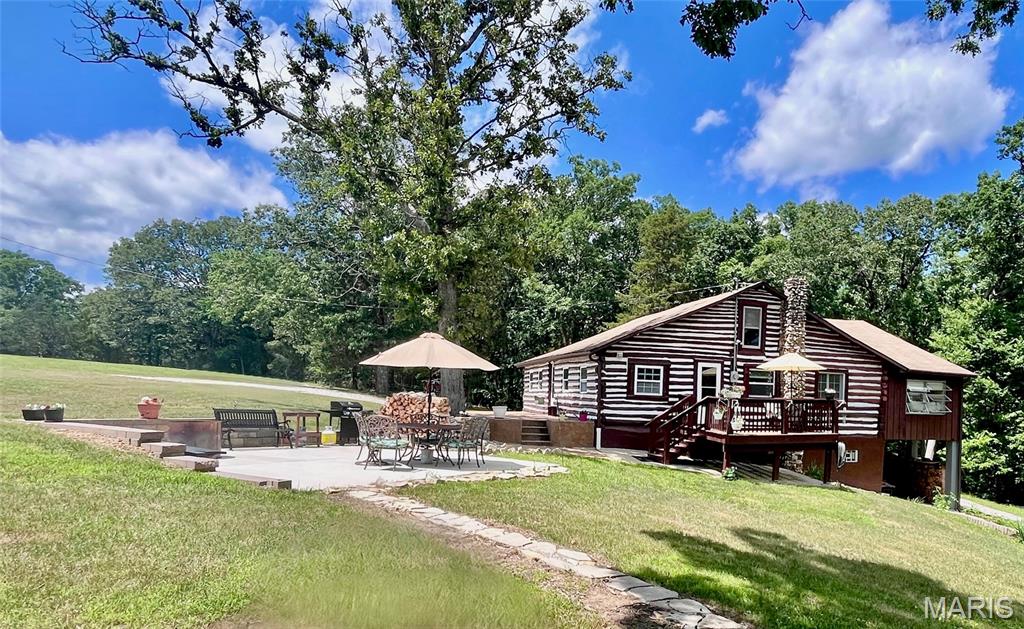 LUXURY RUSTIC RETREAT FOR LEASE: Fully Furnished 2-bedroom Log Cabin can accommodate 4-5 persons on 40 Private Acres! Escape to your own private paradise with this spectacular log cabin nestled on a breathtaking 40-acre estate. Perfectly blending rustic charm with modern comfort, this expansive property offers ultimate privacy and endless room to relax both indoors and out. 

ENTERTAINING & LIVING SPACES Fully Equipped Eat-In Kitchen: Features a range, microwave, refrigerator, with a walk-out to the porch area to soak up the sun. Grand Family Room: Extra-large, ultra-comfortable living space complete with a dedicated dining area and a mounted TV above the fireplace. Sunlit Game Room: A vibrant sunroom tailored for game nights or poker, complete with a cozy, custom built-in window nook bed.

COUNTRY LIVING & EXTRAORDINARY OUTDOORS - Your Private Oasis: Explore pristine acreage featuring a pond, perfect for peaceful strolls and scenic views. Farm animal friendly - bring your horse, chickens or goats! The property includes a corral. Ultimate Relaxation Patio: Unwind on a beautiful 9’ x 20' concrete patio, ideal for relaxing by a fire while gazing at the meadows on one side and a lush wooded backdrop on the other. Cozy Stone Fireplace: Stay warm on chilly evenings with a striking wood-burning fireplace. Fresh firewood is already chopped, stacked, and ready with easy access. Expansive Circle Driveway: A large gravel circle drive provides effortless parking for guests, including an attached carport in the back of the house, and with ample room to park an RV on the driveway.

LEASE TERMS & DETAILS Furnishing Flexibility: Move right into a fully-furnished home, or choose to bring your own personal pieces—the choice is yours! Terms: Seeking long-term stability with a 2-year lease minimum. Tenant is responsible for utility bills. 

Easy Move-In: Straightforward upfront costs require only the first month's rent plus a security deposit equivalent to one month's rent.  

All applicants subject to a full credit, background, and rental history check at the applicant's cost of $39.99 via Rent Spree at https://apply.link/BrkLCj0.  Pets are considered on a case-by-case basis with a non-refundable pet deposit.