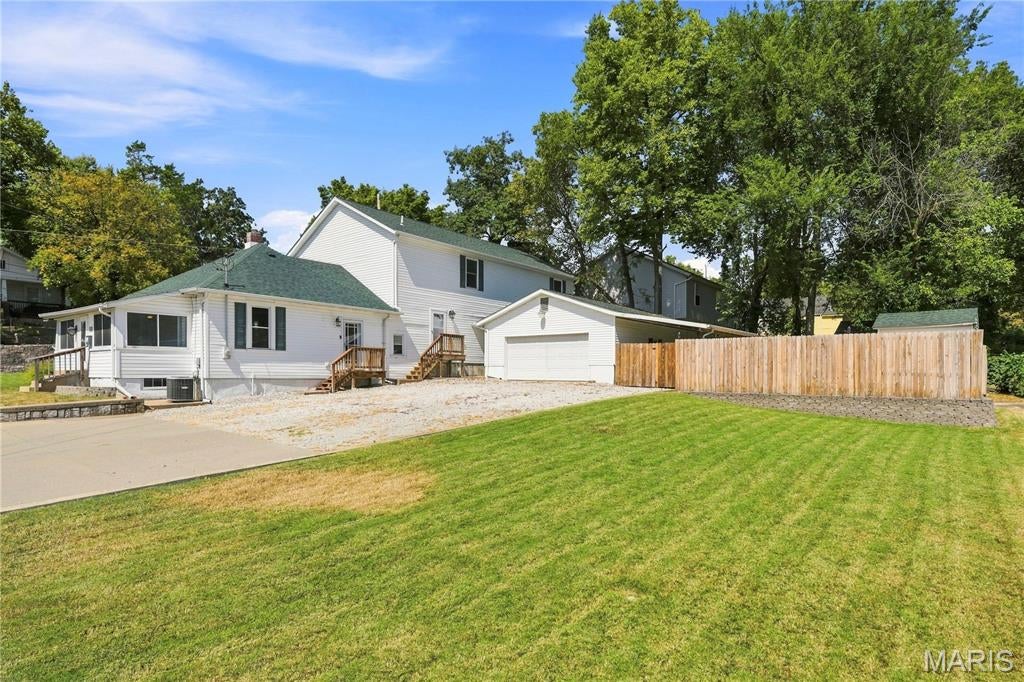 Welcome home to this one-of-a-kind property where space, versatility, and functionality come together. The home features flexible living areas, a spacious newer addition, and custom trim work throughout. Enjoy the sunroom, a large upstairs recreation room, or the outdoor patio with a fire pit in the fenced yard.
The expansive primary suite boasts French doors opening to a covered 37' x 9' deck, while the primary bathroom features dual walk-in closets, an updated bath with a bench shower, and a private water closet. Additional features include an office/flex room, two generously sized bedrooms with walk-in closets, and a Jack-and-Jill bathroom with separate vanities.
The property offers parking for up to 12 vehicles, an oversized garage with 220V service and a hardwired air compressor, an additional half bath (roughed in for a full bath), a covered carport, storage shed, newer fencing, and a concrete patio with a fire pit. The basement provides ample storage space, adding even more functionality to the home. For added peace of mind, the roof was replaced in September 2025, per seller.
This property offers a unique combination of flexible living space, extensive parking, and functional amenities.