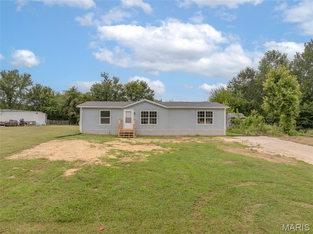 Showings Begin 8/13. Freshly remodeled and ready for its new owner! This 3 bedroom 2 bathroom manufactured home has just been completely gone through with a full update including LVP flooring through its entirety, completely dry-walled, new cabinets, new counter tops, new fixtures, THE WORKS! All bedrooms are good sized with walk in closets and the living room is absolutely massive with a vaulted ceiling. Master bedroom has ensuite bathroom with a double vanity and seperate tub and shower. Kitchen is a galley style with plenty of cabinet space and butcher block counter tops. Coming in from the back door you'll find a mudroom with laundry hookups, perfect for coming home after a long days work. All of this sits on just under a half acre right outside of Moscow Mills and a short drive to both Highway 61 and 79.
