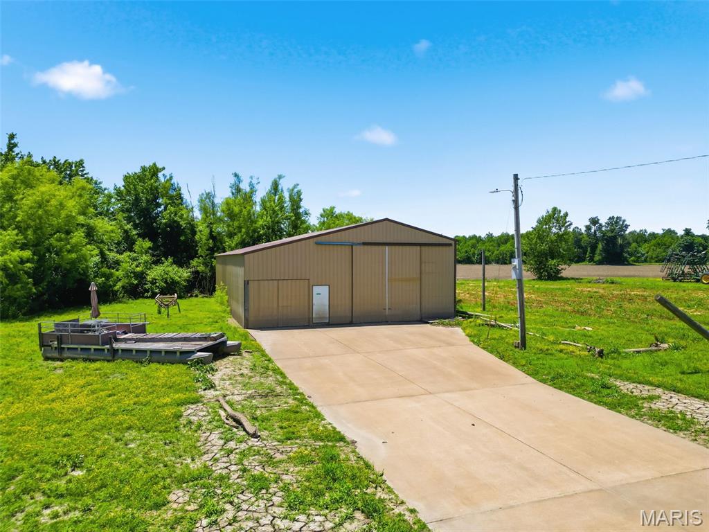 Excellent opportunity to own a versatile 0.35-acre property, featuring a 42' x 60' outbuilding, with a spacious 12' x 60' loft. The building offers both a 14-foot overhead door and a 9-foot overhead door, providing easy access for RVs, boats, equipment, or large vehicles. Additional features include concrete floors, 200-amp electrical service, and ample space for storage, a workshop, or hobby enthusiasts. Conveniently located and ready for a variety of uses. This property can be bought with the house located at 39070 Pike 202 Annada for $159,900 MLS#26035213