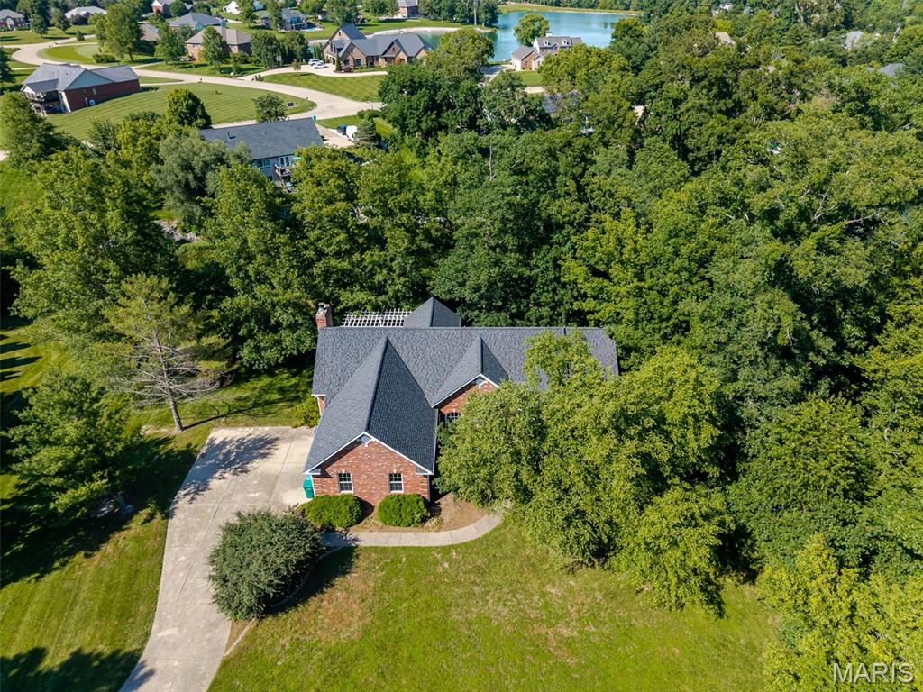 Stunning Lakefront Estate in Sought-After Wildwood Estates!
Welcome to your private oasis in Smithton. Situated on a sprawling 1.12-acre lakefront lot, this impressive estate offers a perfect blend of elegance and space. Boasting 3 bedrooms, 2.5 bathrooms, and a massive estimated 4,290 total square feet of finished living space (2,290 main level / 2,000 lower level), this home is designed for both grand entertaining and comfortable everyday living.
Main Level Highlights:
Grand Entry: Step through the foyer to find a formal dining room and a private den, perfectly framed by 9’ ceilings and gleaming wood floors.
Sun-Drenched Living Space: The living room features a breathtaking wall of windows with transoms, flooding the home with natural light.
Chef’s Kitchen & Hearth Room: The kitchen is a standout with crisp white cabinetry, built-in appliances, and a unique butterfly island topped with quartz. It flows seamlessly into the breakfast room—featuring a custom palladium window and deck access—and an inviting, vaulted hearth room centered around a gas fireplace with custom built-ins. Luxury Primary Suite: A true retreat featuring double doors, a large walk-in closet, and a spa-like ensuite complete with a pocket door, double bowl vanity, large soaking tub, and separate shower.
Convenience: A main-floor mudroom, powder room, and dedicated laundry room with a utility sink add effortless functionality.
Finished Walk-Out Lower Level: The expansive lower level features a 9’ pour and walk-out access, making it feel like a second home. It includes 2 spacious bedrooms, a full bathroom, a large family room, and a full bar area and kitchenette—ideal for an in-law suite or the ultimate recreation space.
Additional Features:
Energy-efficient Geothermal HVAC system.
Ample storage room.
Roof 2024.
Please note: This property is an Estate and is being Sold As-Is.  Listing broker has attempted to offer accurate data & info is deemed reliable but not guaranteed. Square footage may not be accurate. Buyers & agents are responsible for verifying accuracy.
