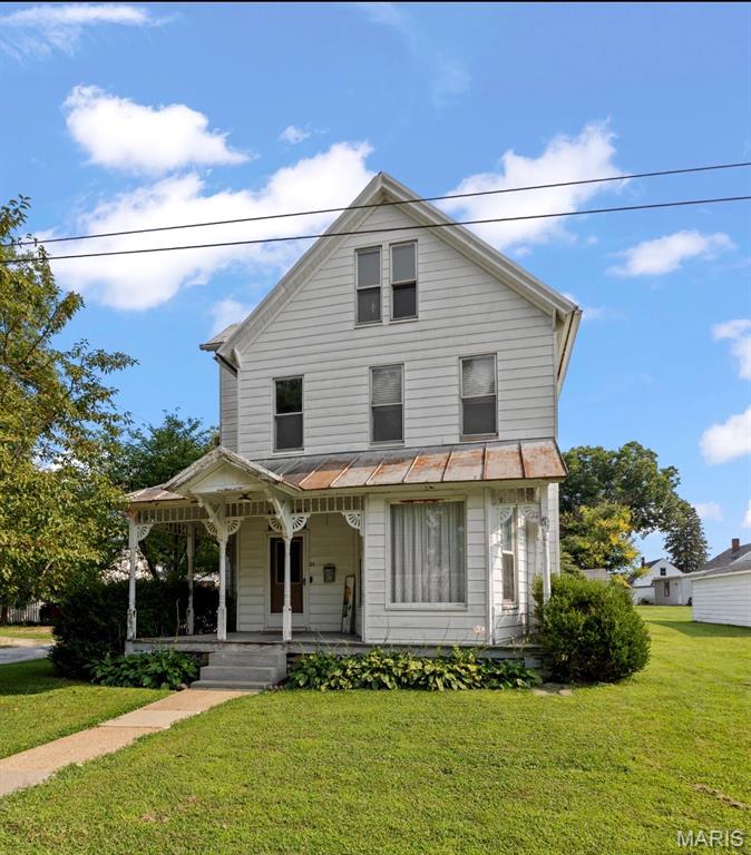 Charming 1901 farmhouse full of character and potential. This lovely home features real hardwood floors and tall ceilings throughout, original crown molding and baseboards, and a striking spiral foyer staircase that sets the tone from the moment you enter. The main level offers a partially updated kitchen, dining room, living room, full bathroom, and convenient laundry - an ideal layout for everyday living.
Three bedrooms occupy the second floor with space to add a bath or a large walk-in closet. The third level provides flexible bonus space that could be finished into an extra bedroom, office, playroom, or media room. Additional highlights include a covered front porch, partial cellar basement, detached garage with carport, large backyard, and durable metal roof.
Well suited for renovation and modernization while preserving historic details, this home is a great opportunity for buyers seeking classic charm with room to personalize. Schedule a showing to explore the possibilities! Selling "AS IS"