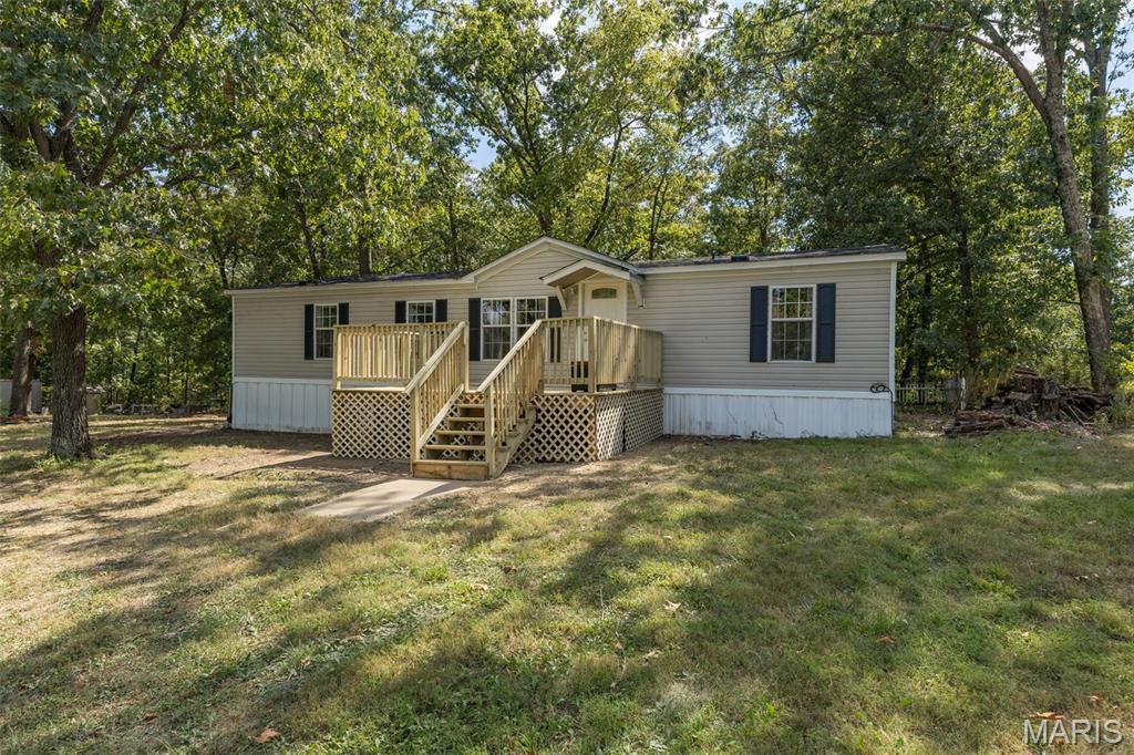 Is nature calling your name??
1852 Lake St. is tucked away in a beautiful gated lake community offering lakes, trails, fishing, a beach and plenty of seclusion—all while giving you a place to truly feel at home.
Situated on over an acre of ground and backing to woods, this property offers plenty of room for gardening, outdoor projects, pets and privacy. A circle driveway provides plenty of parking, and the detached garage adds even more space for vehicles, storage, hobbies or weekend projects.
Step inside to a spacious living room with an open-concept dining area and kitchen. From the minute you walk through the front door, natural light floods the space through the new sliding glass door. The roomy kitchen offers an abundance of cabinetry and counter space, making it easy to gather and entertain. The utility and laundry room has its own side entrance—the perfect spot to kick off muddy shoes after a day outside—with plenty of additional room for storage.
The split-bedroom floor plan gives the primary suite its own space to unwind, complete with a large closet and private bathroom. Two additional spacious bedrooms offer great closet storage and flexibility for family, guests or a home office.
With over an acre, wooded views, lake-community amenities and room to spread out, this is the kind of property that makes you want to slow down and enjoy where you live.
Close just in time to settle onto your new deck, watch the leaves begin to turn  ??